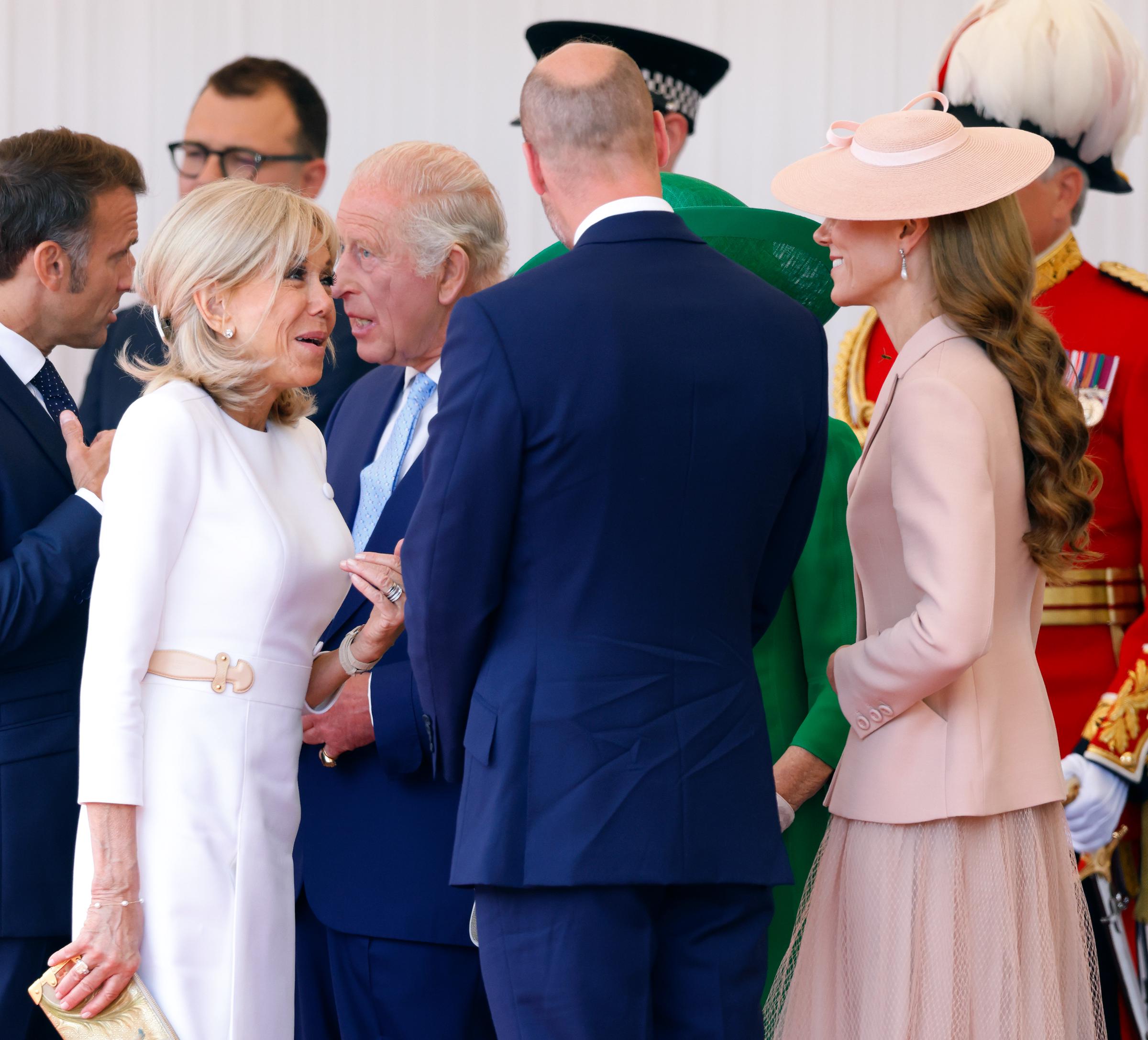 Brigitte Macron, Prince William, and Catherine, Princess of Wales, engaged in conversation at the formal welcome ceremony held at the Royal Dais on Datchet Road, in honor of French President Emmanuel Macron and the First Lady’s state visit to the United Kingdom.