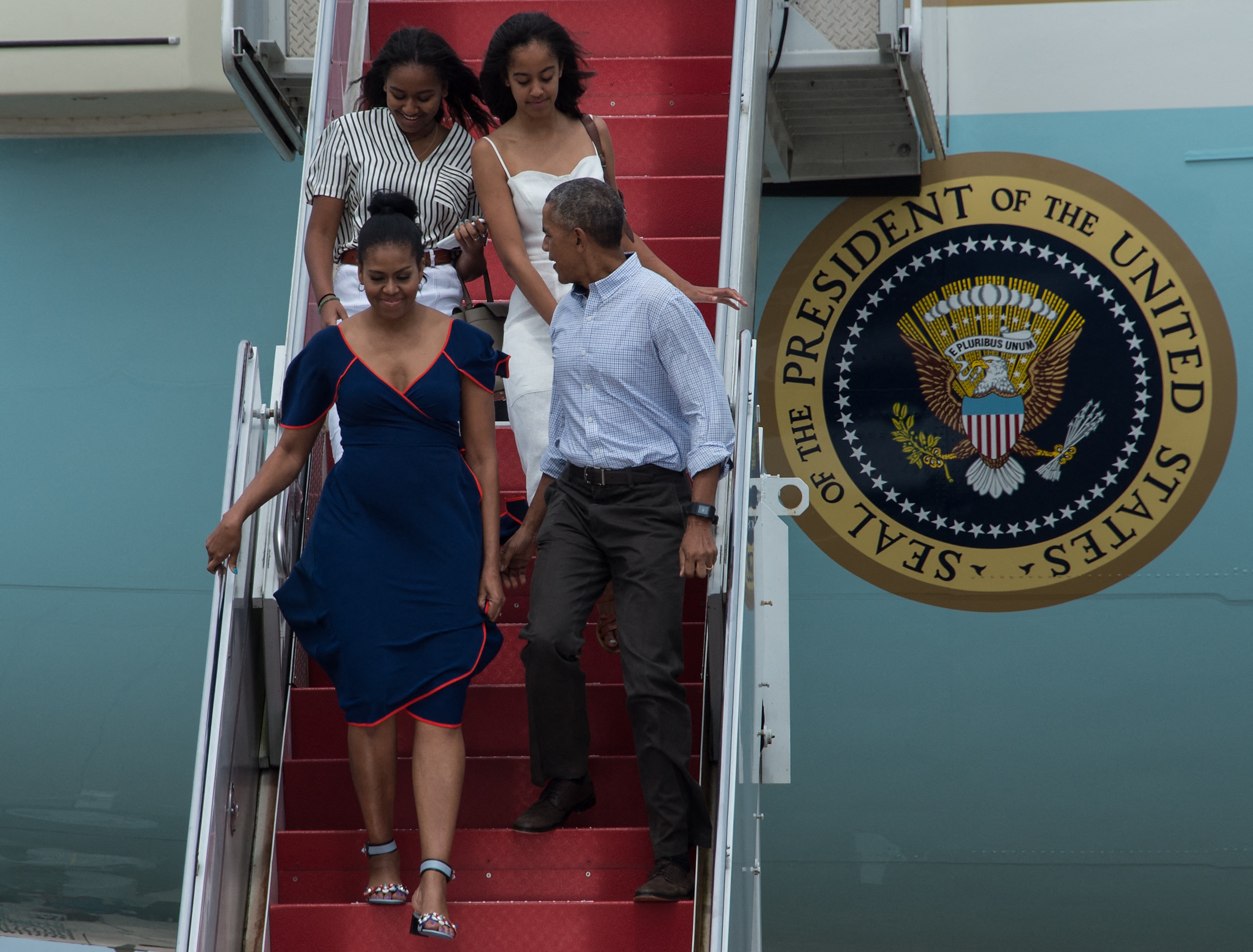 Michelle, Barack, Sasha, and Malia Obama disembarking from Air Force One at Cape Cod Air Force Station in Massachusetts on August 6, 2016. | Source: Getty Images