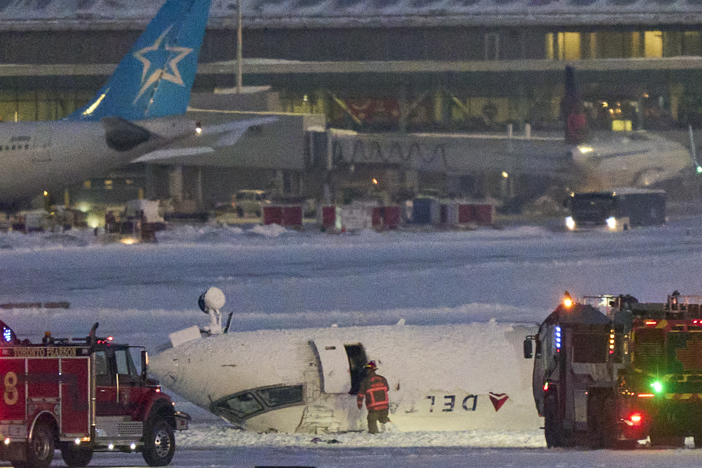 A Delta Air Lines plane sits on its roof after crashing upon landing on February 17, 2025, in Toronto, Canada. | Source: Getty Images