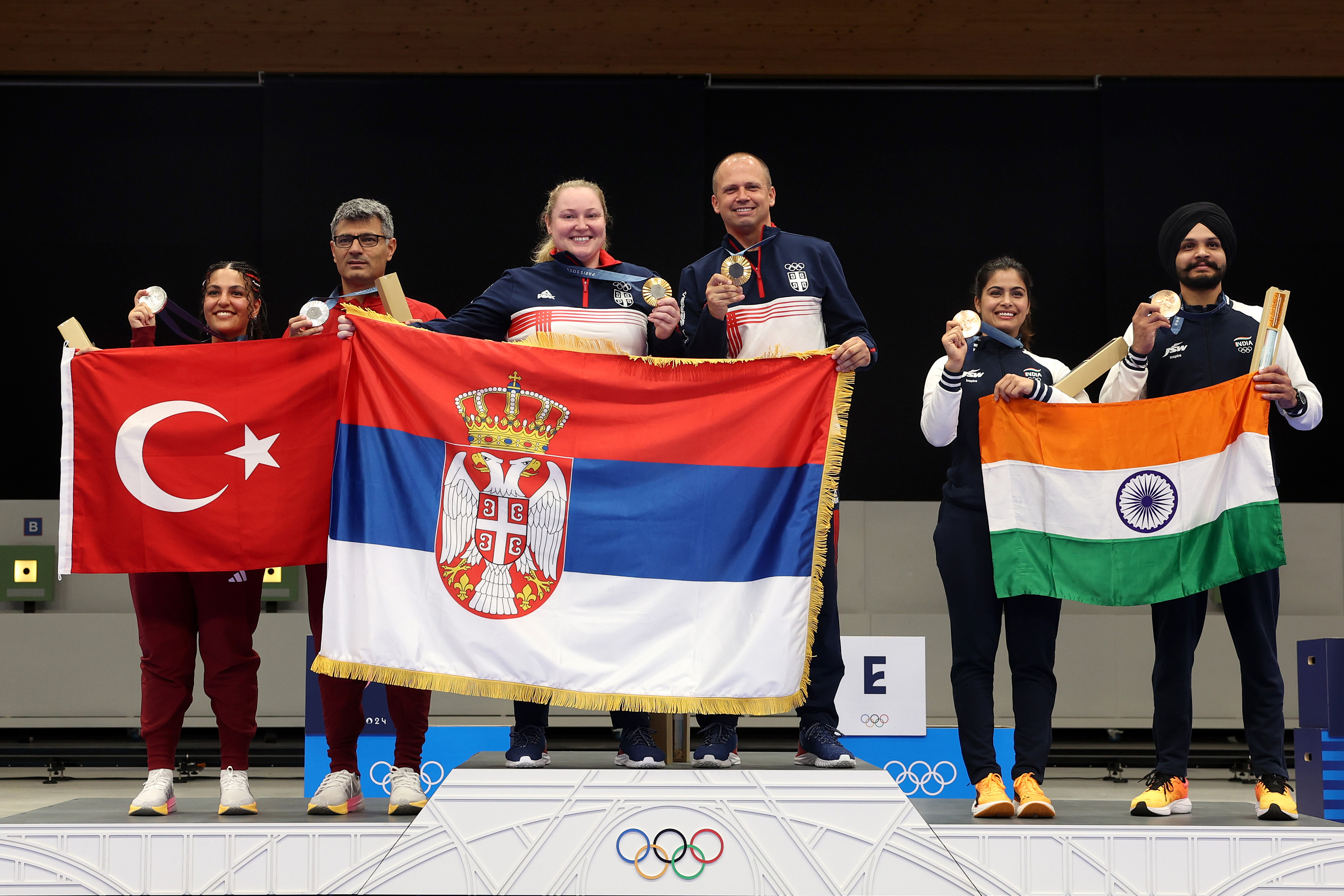 Sevval Ilayda Tarhan and Yusuf Dikeç, Zorana Arunovic and Damir Mikec, and Manu Bhaker and Sarabjot Singh pose on the podium during the Shooting 10m Air Pistol Mixed Team medal ceremony at the Paris Olympic Games Paris on July 30, 2024, in Chateauroux, France | Source: Getty Images