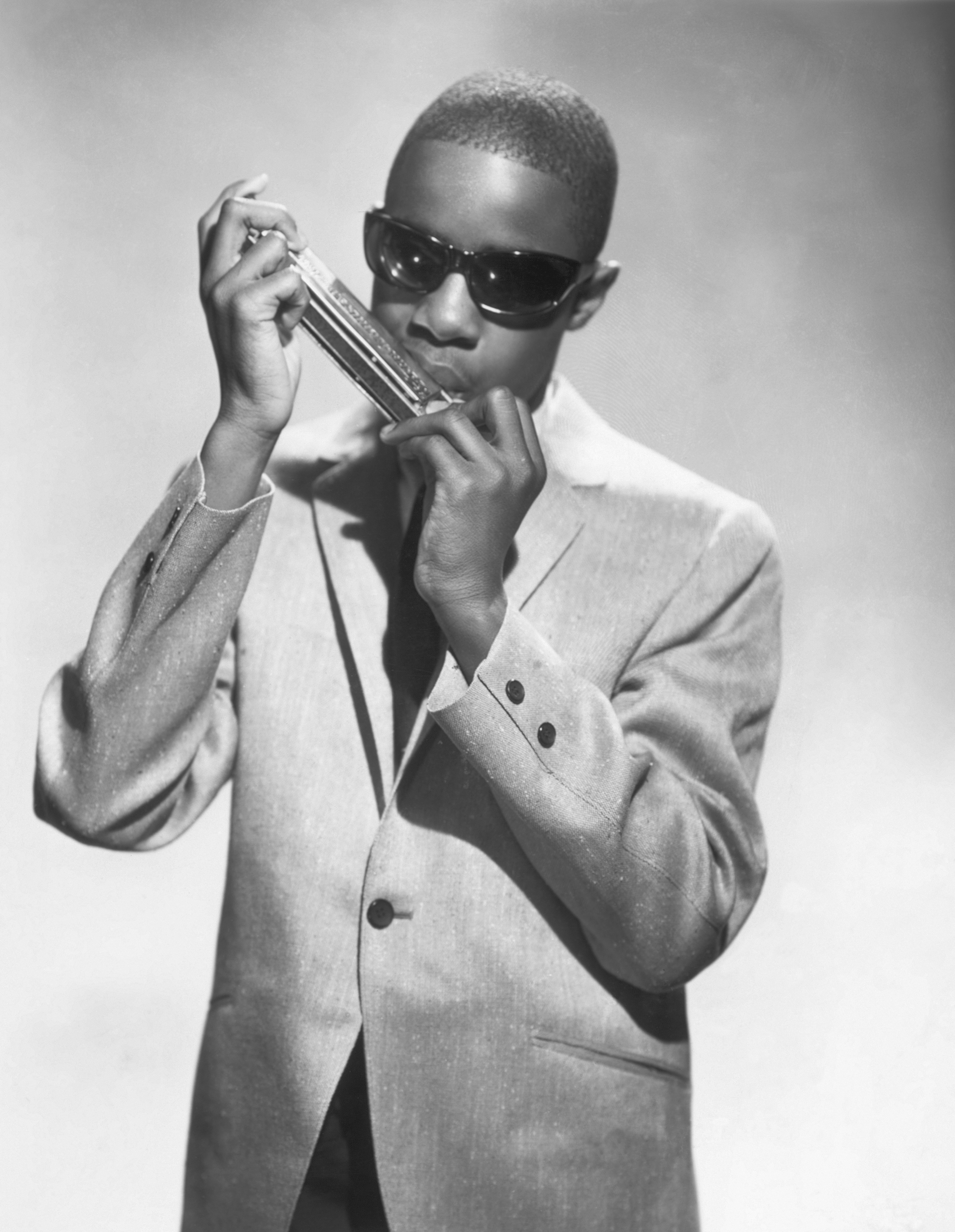 Stevie Wonder playing a harmonica on January 1, 1960 | Source: Getty Images