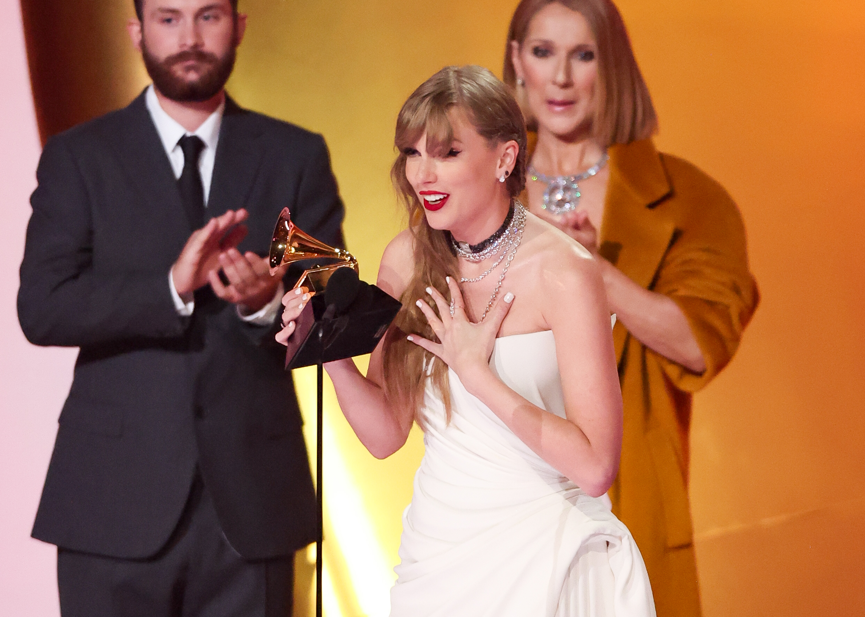Taylor Swift accepts the Album of the Year award for "Midnights" on stage with Celine Dion and René-Charles Angélil at the 66th Annual Grammy Awards in Los Angeles, California, on February 4, 2024. | Source: Getty Images