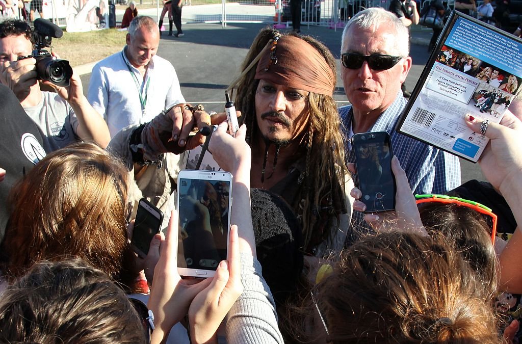  Johnny Depp dressed as Captain Jack greets fans after returning from a day on the film set, in Redland Baybane on June 4, 2015. | Source: Getty Images