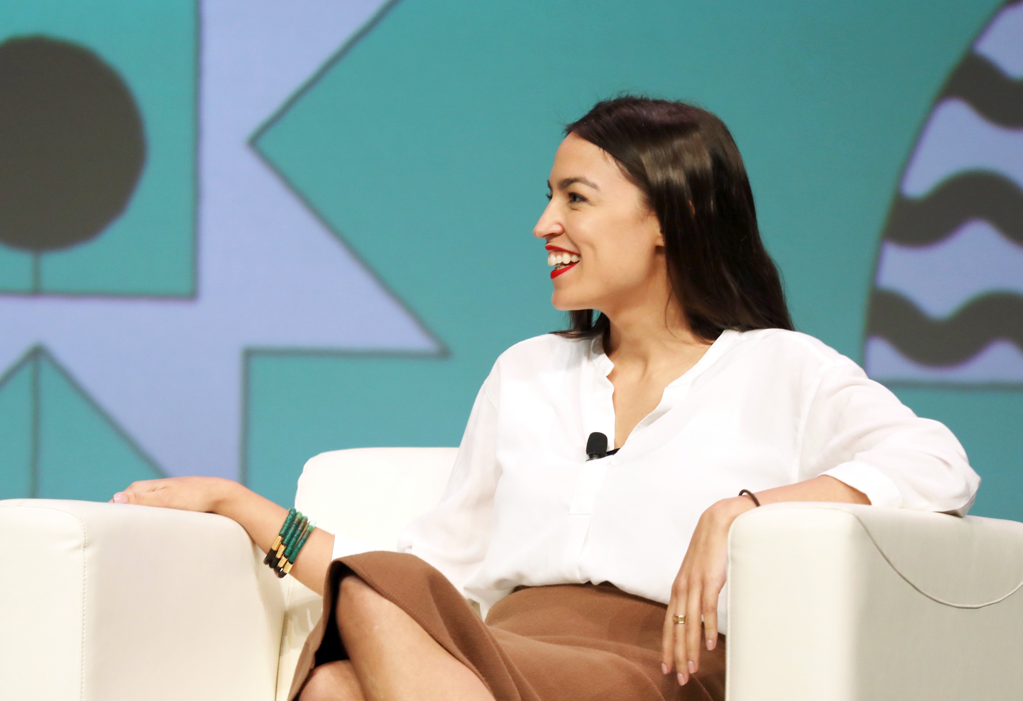Alexandria Ocasio-Cortez sitting on stage at the 2019 SXSW Conference and Festivals in Austin, Texas | Photo: Getty Images