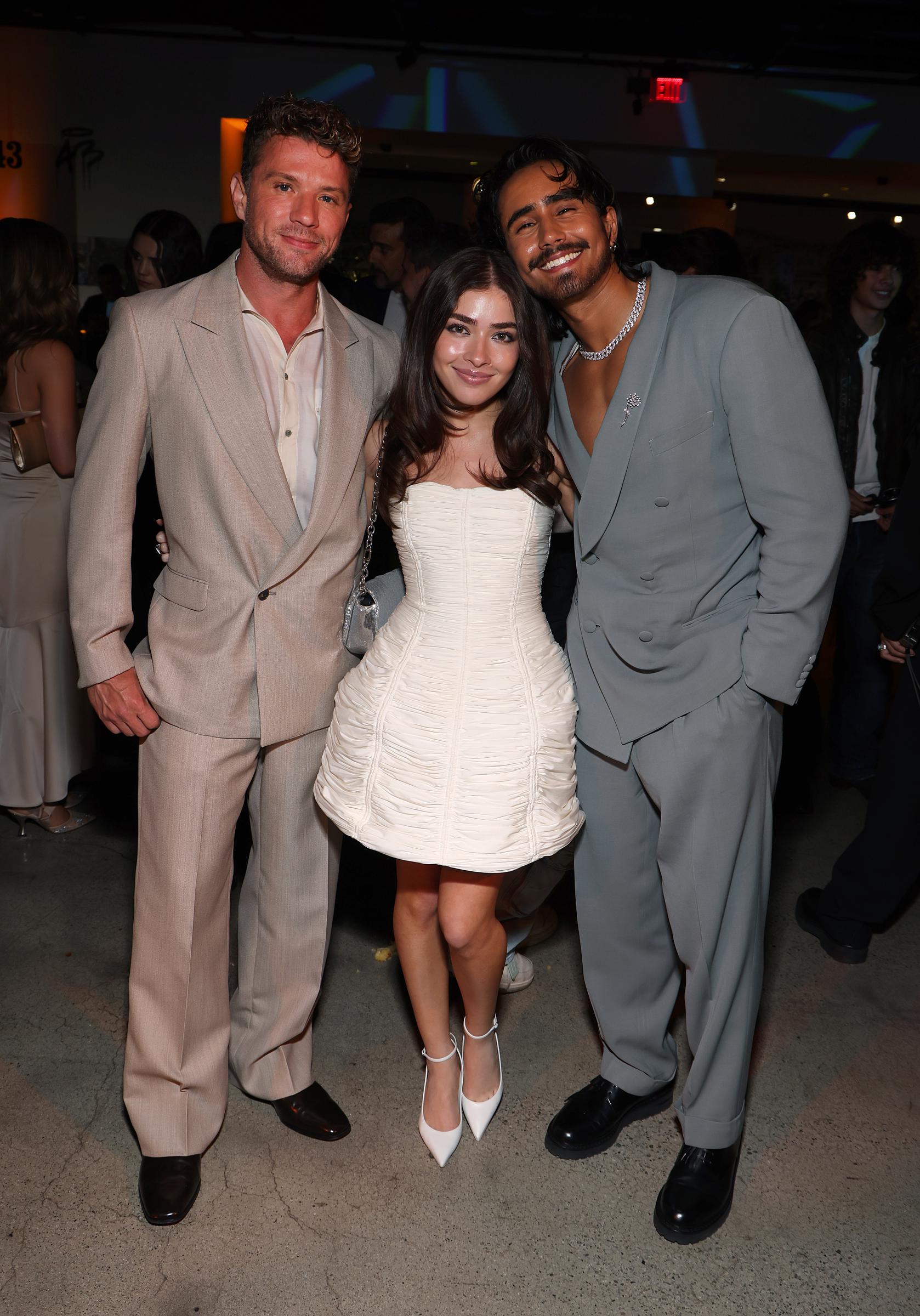 Ryan Phillippe, Melissa Collazo, and Michael Cimino smile for the camera during Prime Video's "Motorheads" screening at the Academy Museum, with Ryan and Michael in coordinating suits and Melissa in a strapless white mini dress.