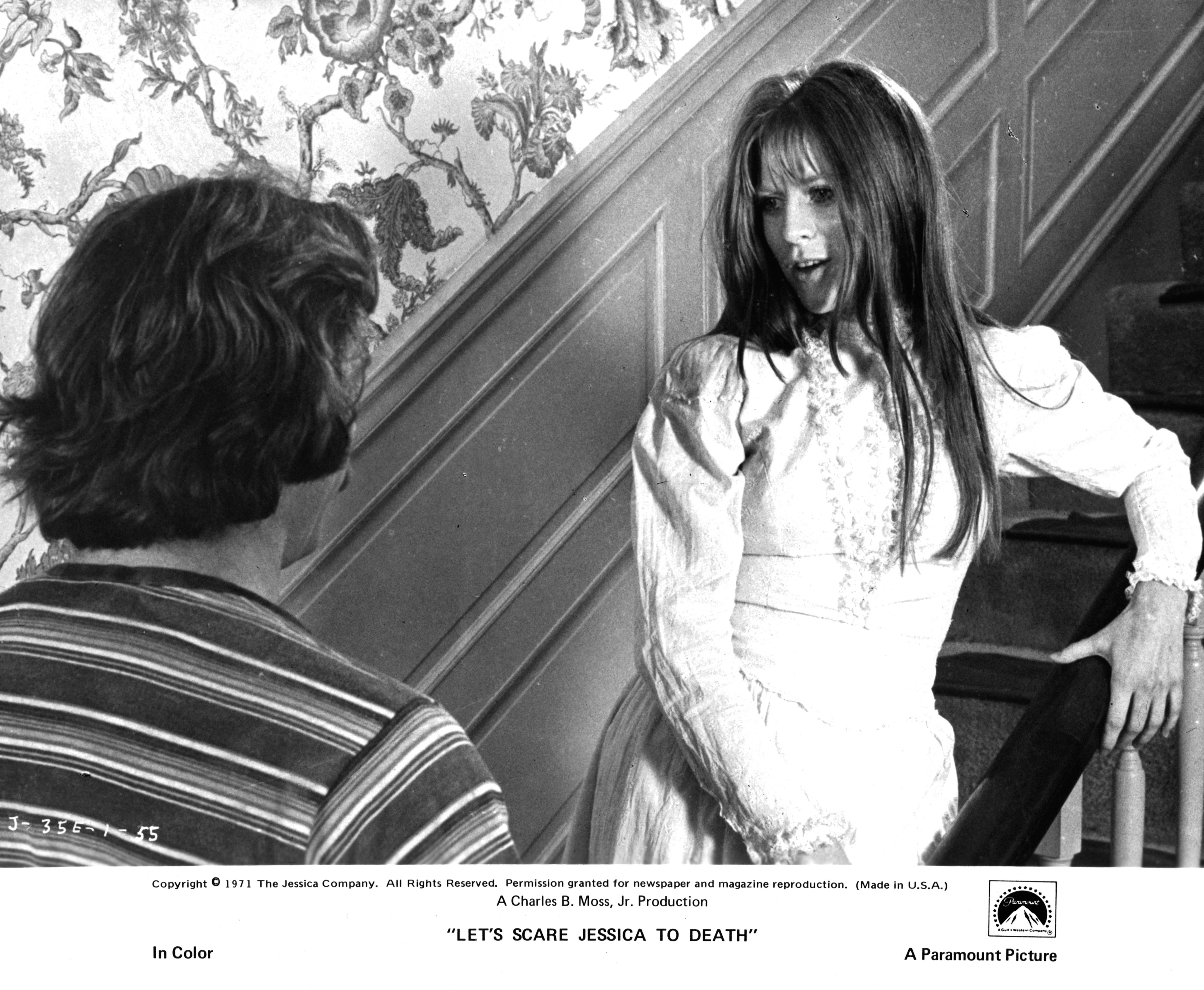 Mariclare Costello stands on the staircase as she talks with Kevin O'Connor in a scene from the film 'Let's Scare Jessica To Death', 1971 | Source: Getty Images