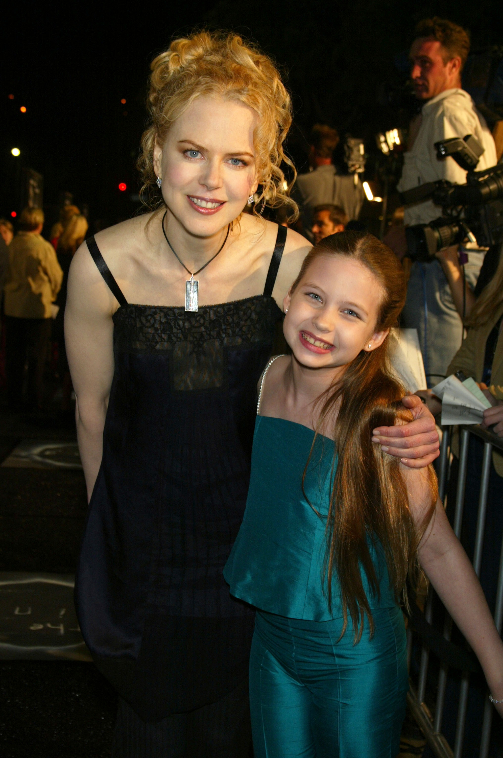 Nicole Kidman poses with Daveigh Chase at the premiere of "The Ring" in Westwood, where the young actress introduced audiences to her chilling portrayal of Samara Morgan. | Source: Getty Images