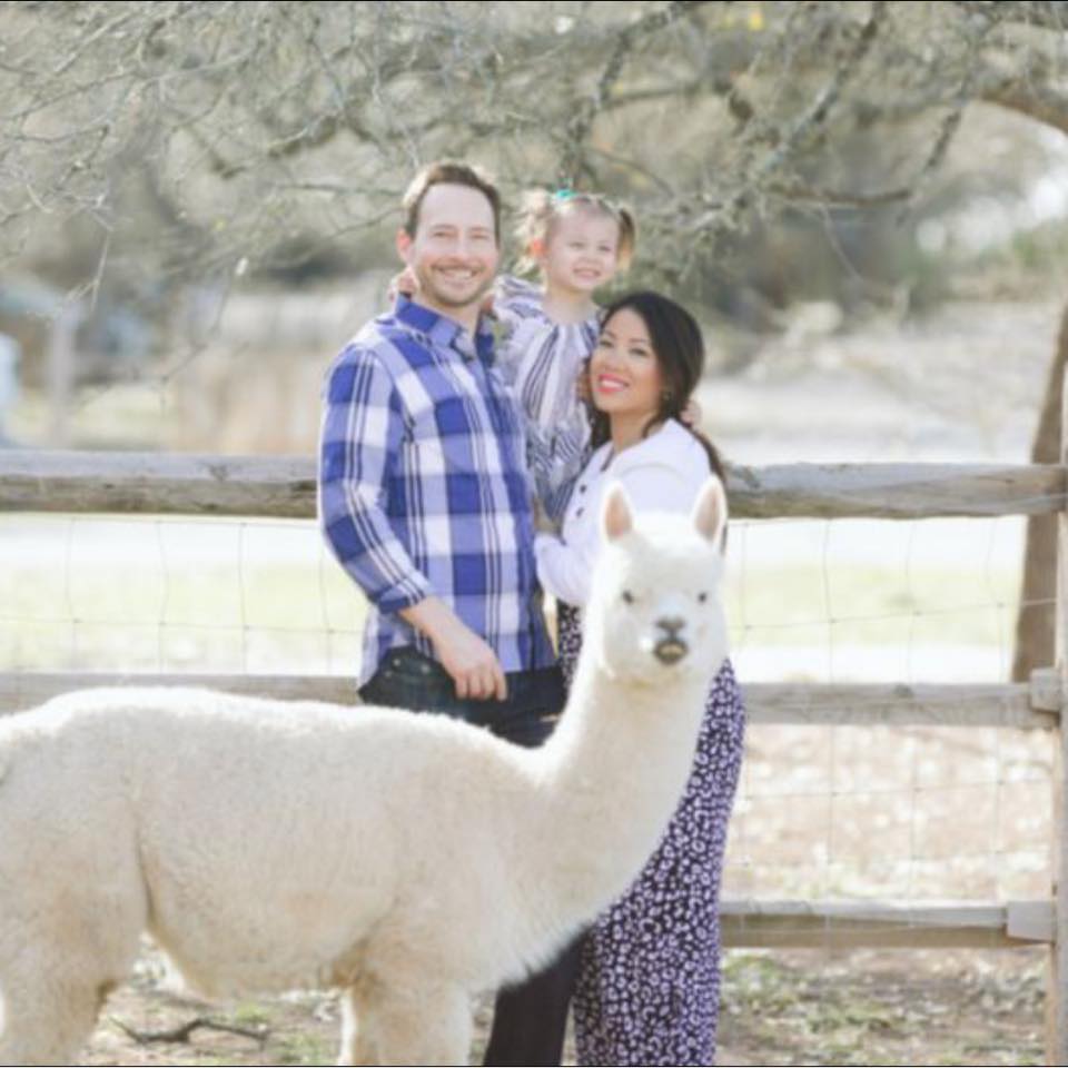 Matthew and Thy Mitchell posing for a family photo with one of their kids, posted on March 18, 2022. | Source: Facebook/Thy Mitchell