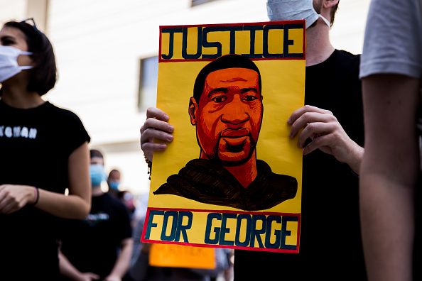 A protester holds a sign commemorating George Floyd during the march to support Black Lives Matter protests on June 06, 2020 in Beverly Hills, California | Photo: Getty Images