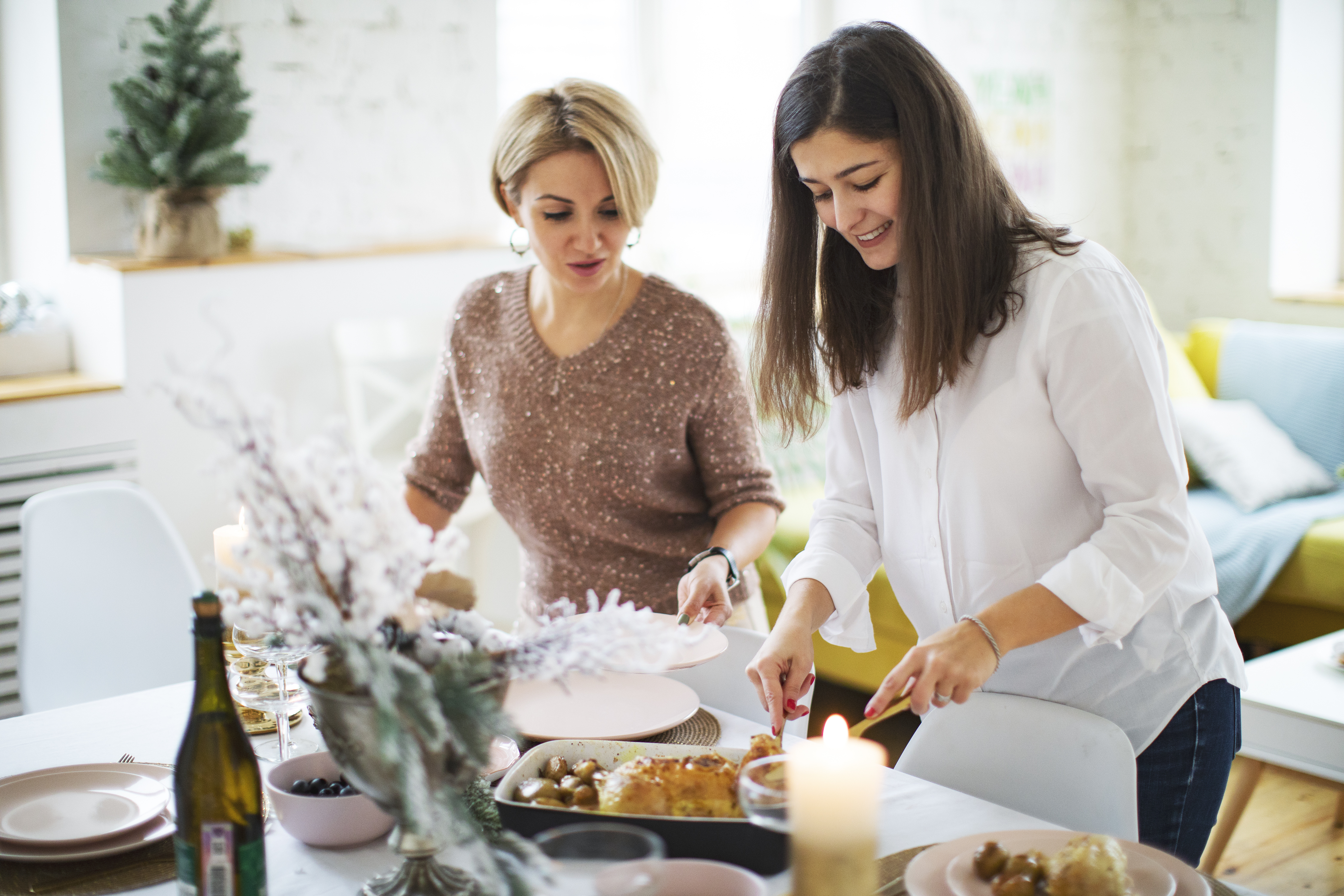 Woman friends setting the table before christmas celebration | Source: Getty Images