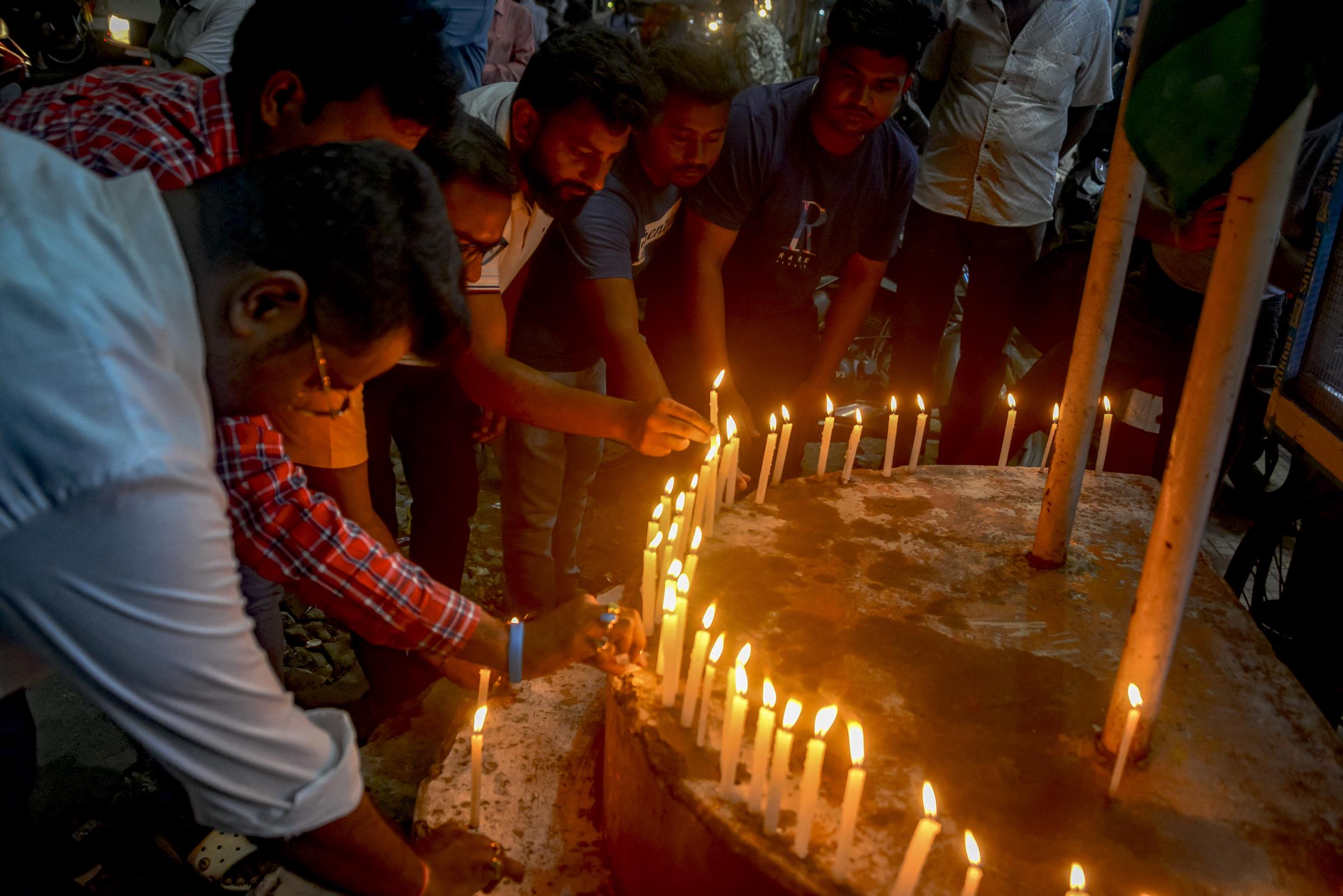 Indian Congress Party supporters lighting candles as they pay homage to the victims of Air India flight 171 which crashed in a residential area near the Ahmedabad airport, India, on June 12, 2025. | Source: Getty Images