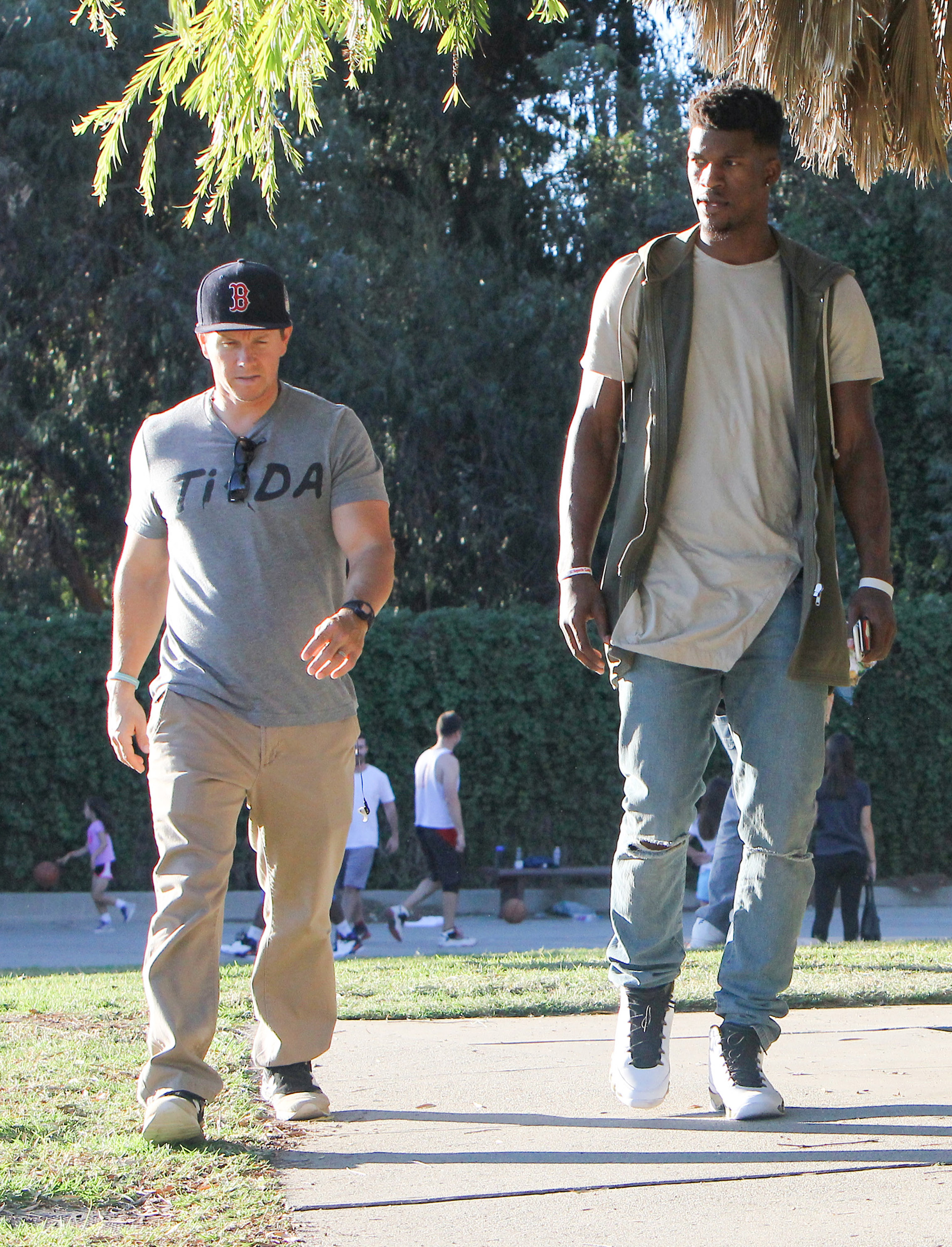 Mark Wahlberg and Jimmy Butler walk along the street on November 21, 2015, in Los Angeles, California. | Source: Getty Images