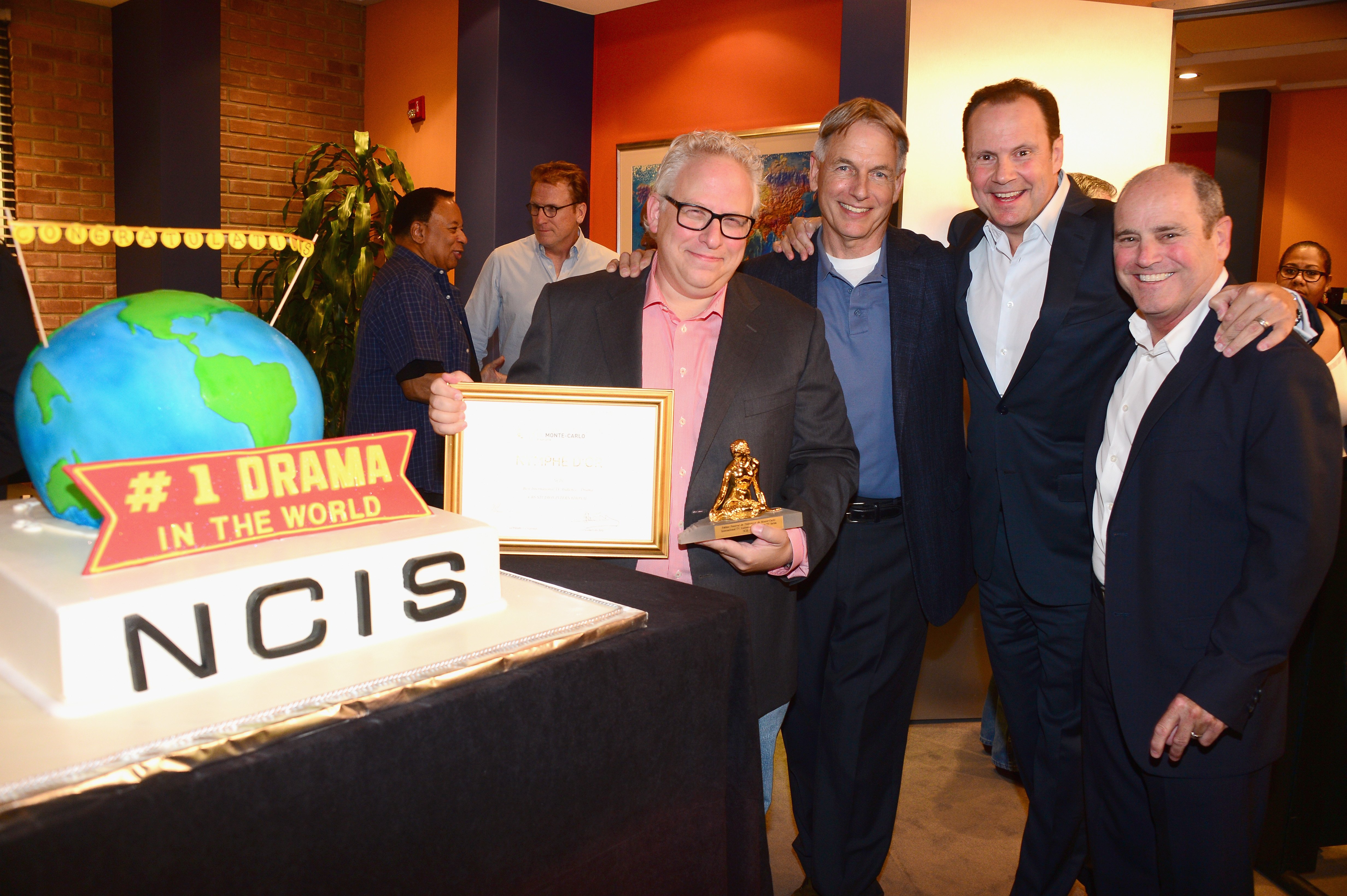 Gary Glasberg, Mark Harmon, Armando Nuñez and CBS Paramount president David Stapf celebrate "NCIS" being named he most-watched drama in the World after receiving the International TV Audience Award at Monte-Carlo Television Festival on August 7, 2014 in Valencia, California | Photo: Getty Images