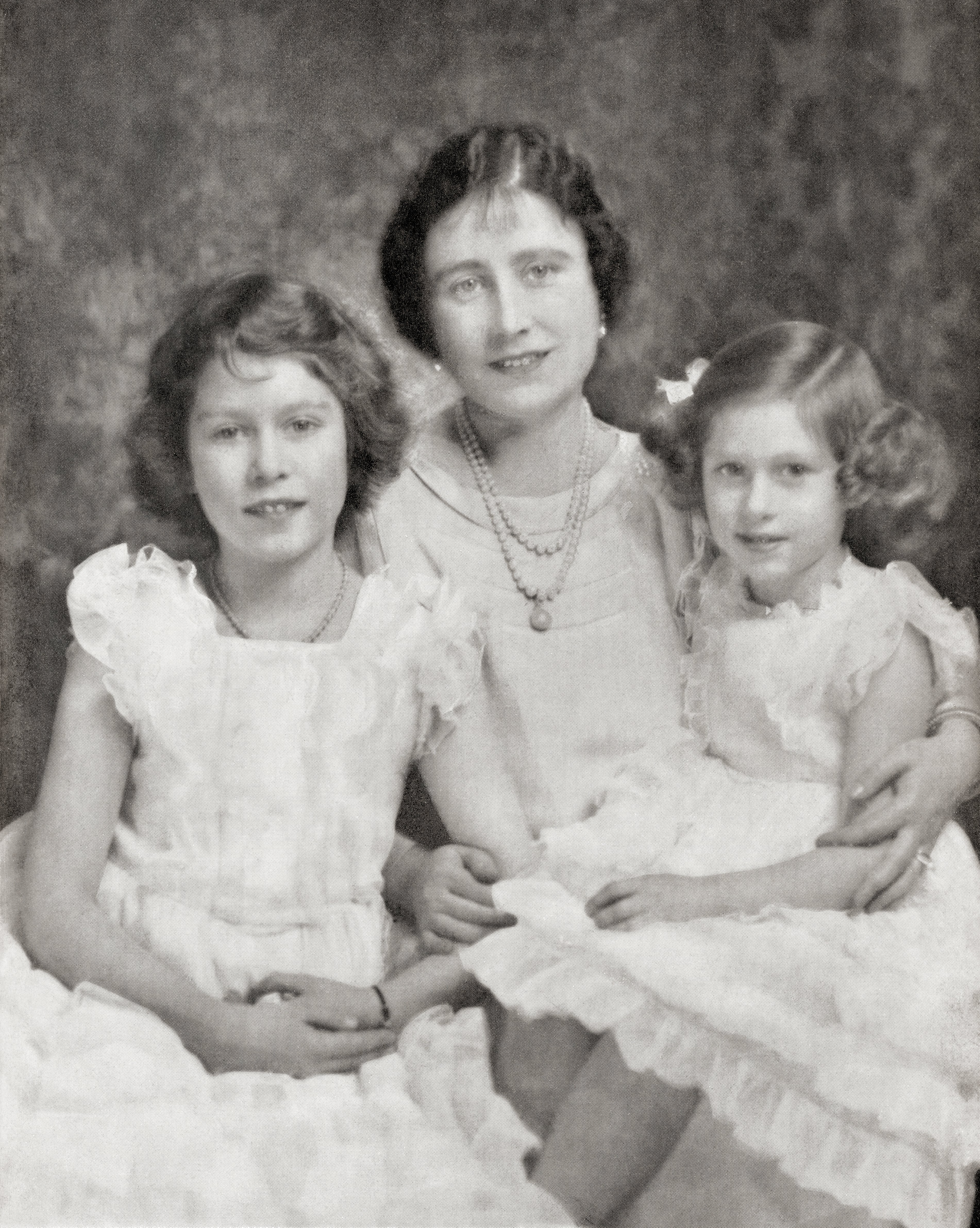 Queen Elizabeth, the Queen Mother, with her daughters Princess Elizabeth, future Queen Elizabeth II, and Princess Margaret,  in 1937. | Source: Getty Images