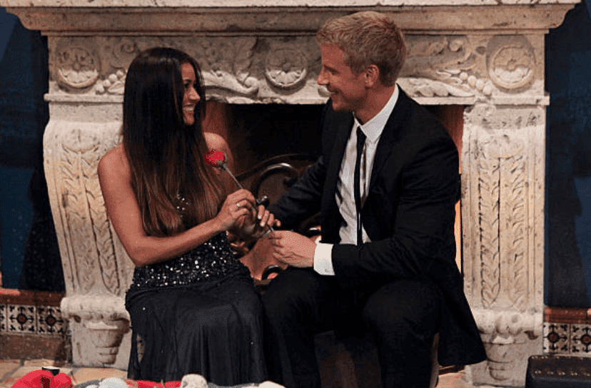 Sean Lowe and Catherine Giudici sit in front of a fire place after he gives her a rose in season 17 of "The Bachelor," on January 7 2013 | Source: Rick Rowell/Walt Disney Television via Getty Images
