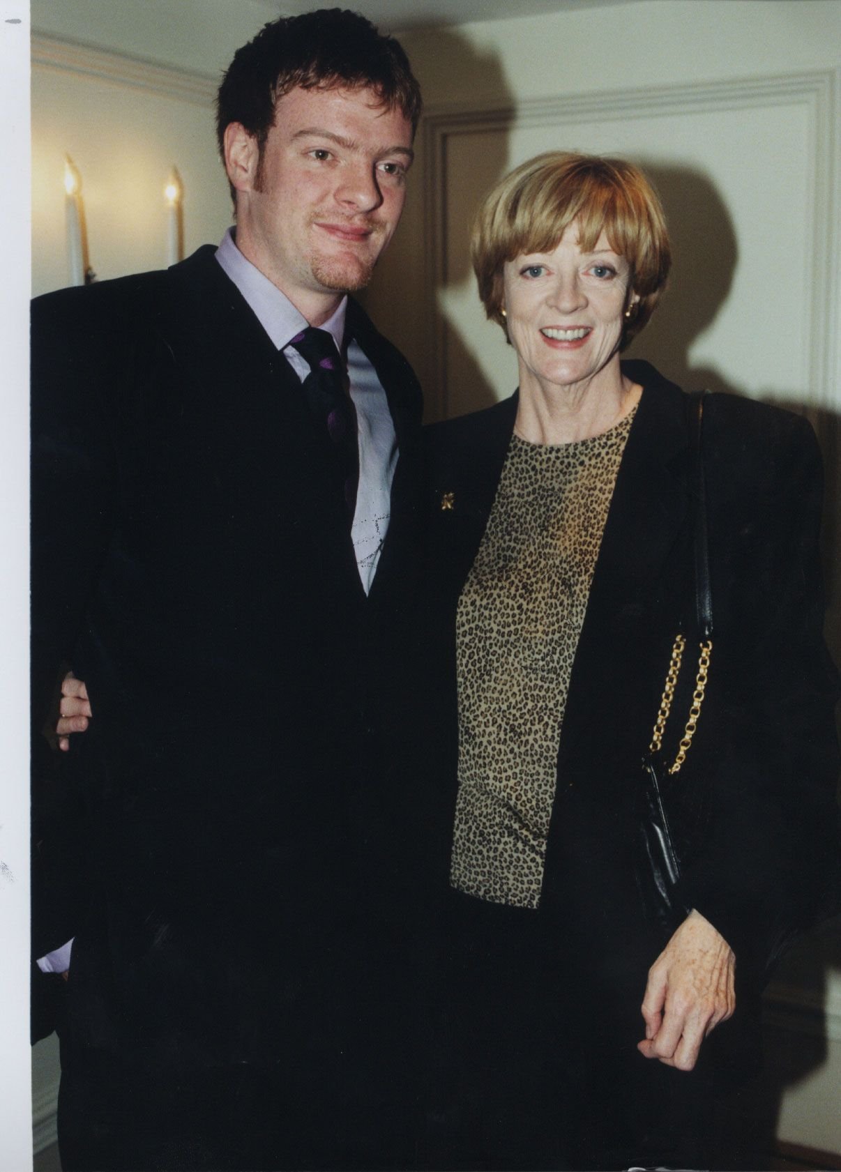 Maggie Smith and her son, Chris Larkin, post for a photo together. | Source: Getty Images