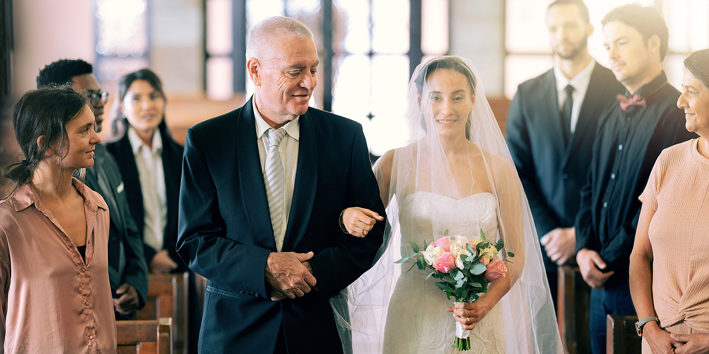A bride walking down the aisle with her father | Source: Shutterstock