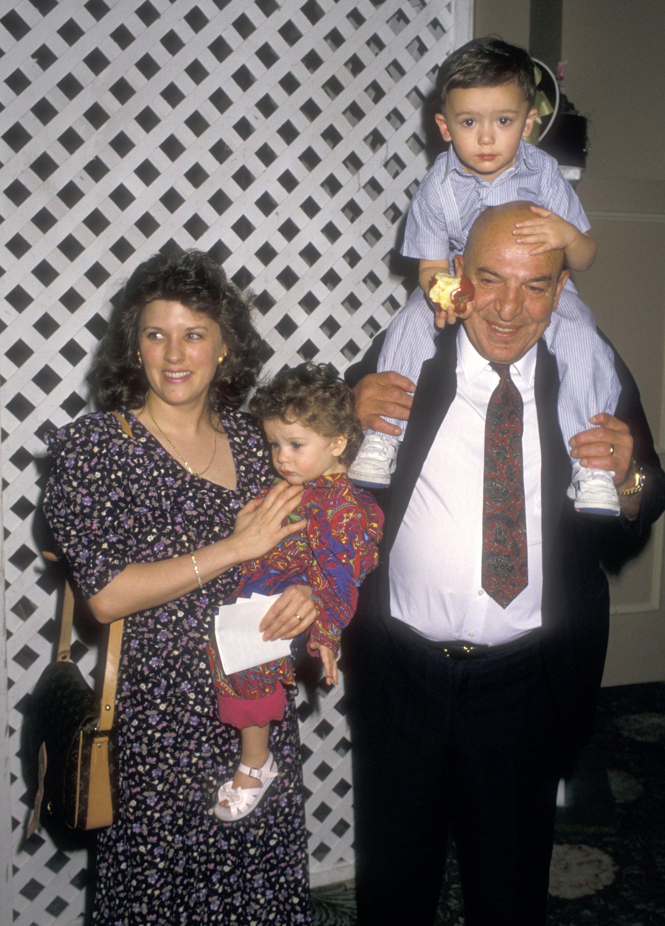 Actor Telly Savalas, wife Julie Savalas, son Christian Savalas and daughter Ariana Savalas attend the Young Musicians Foundation's Seventh Annual Celebrity Mother/Daughter Fashion Show on March 24, 1988 at Beverly Hilton Hotel in California. | Source: Getty Images