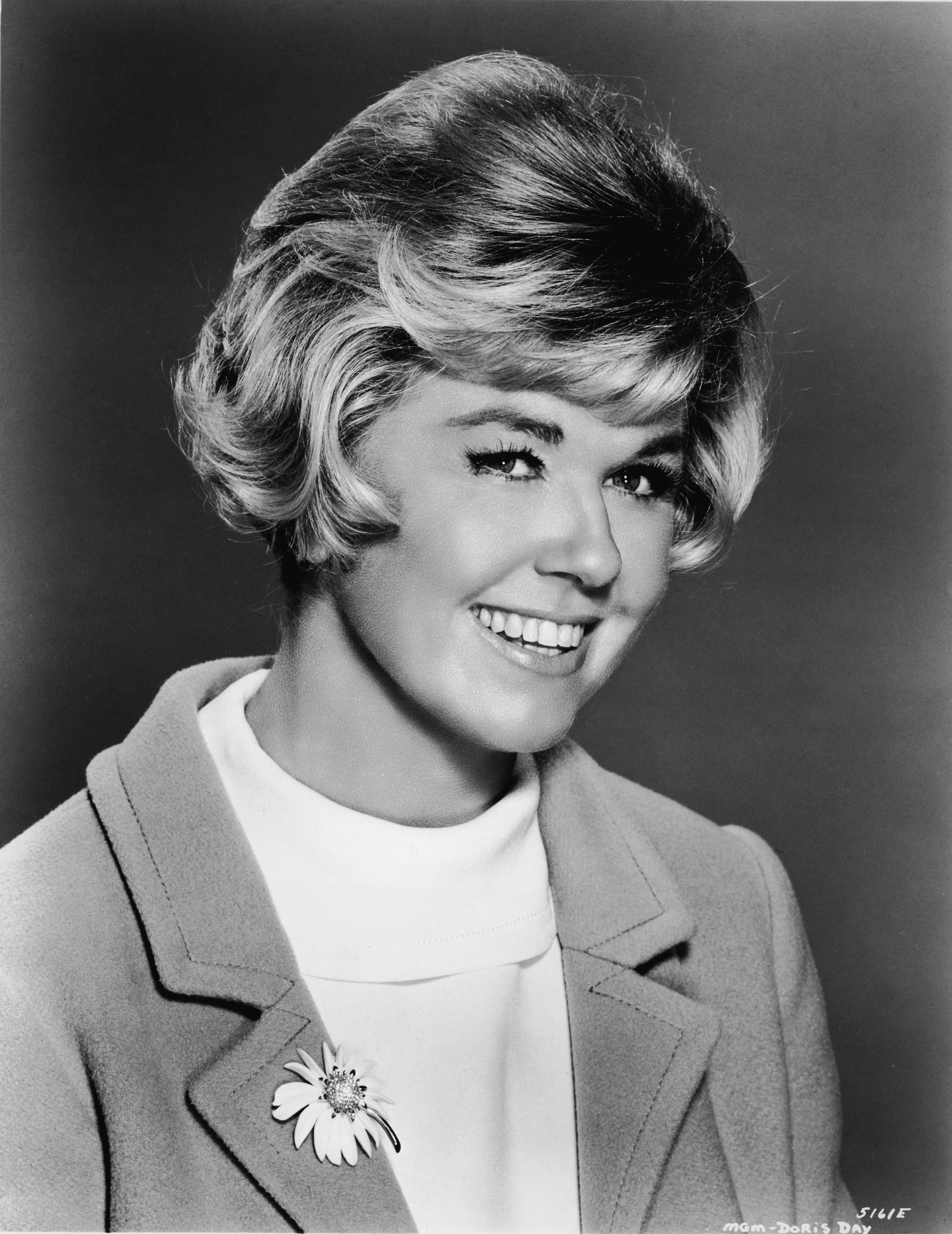Television and movie star Doris Day wearing a coat pinned with a flower brooch in 1966. / Source: Getty Images