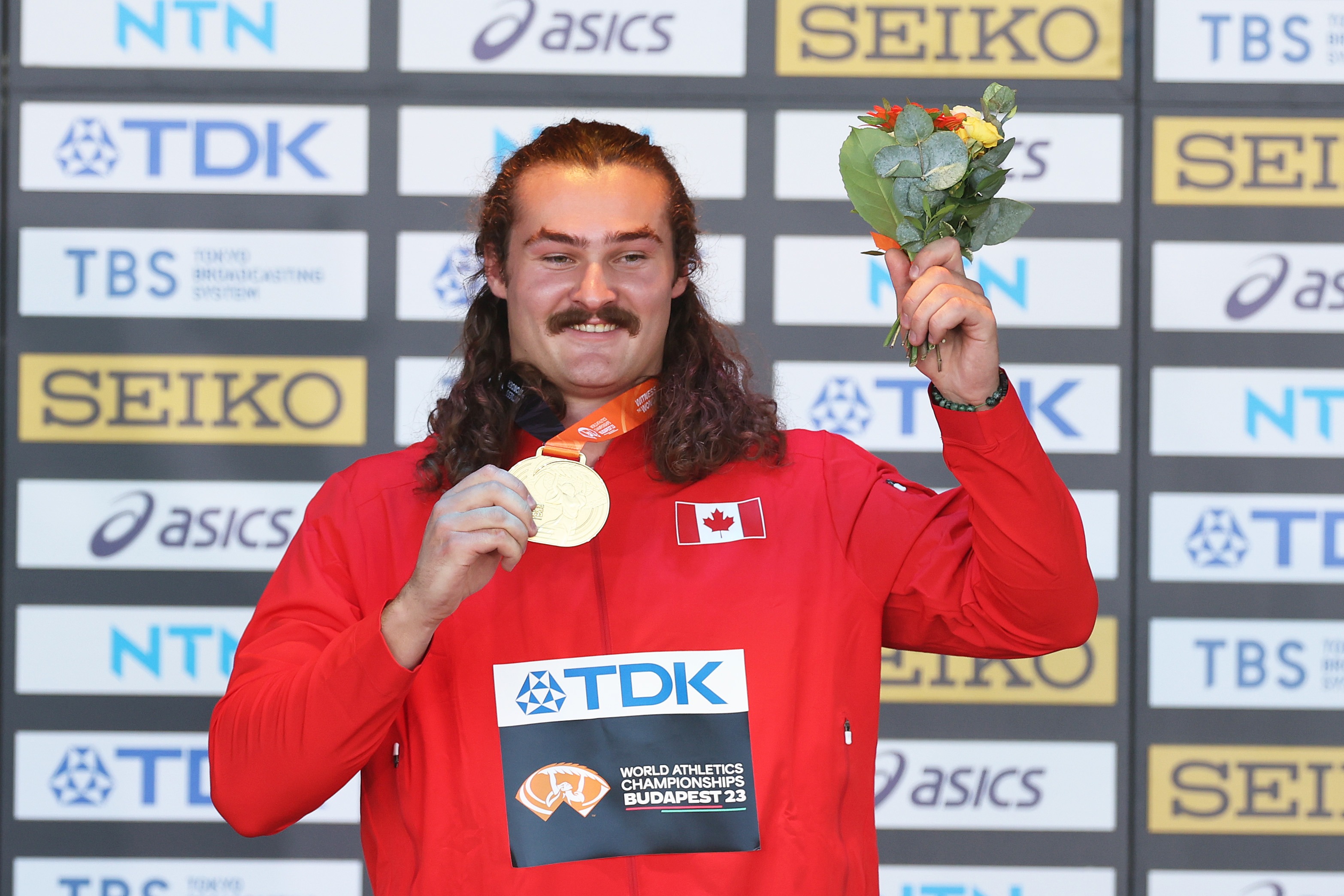 Ethan Katzberg celebrates with his gold medal on the podium during day three of the World Athletics Championships Budapest 2023 at National Athletics Centre on August 21, 2023, in Budapest, Hungary. | Source: Getty Images