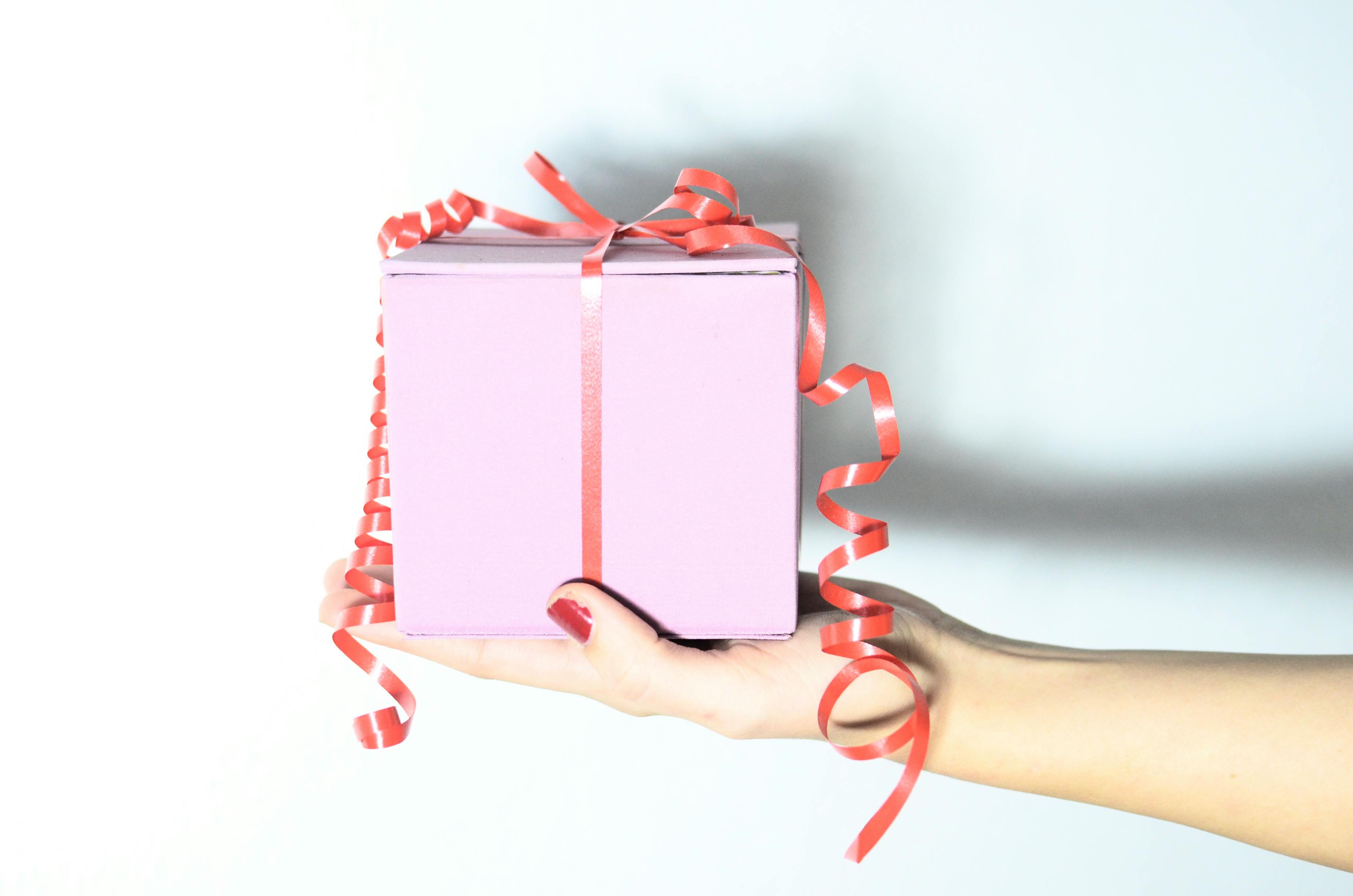 A woman holding a gift box | Source: Pexels