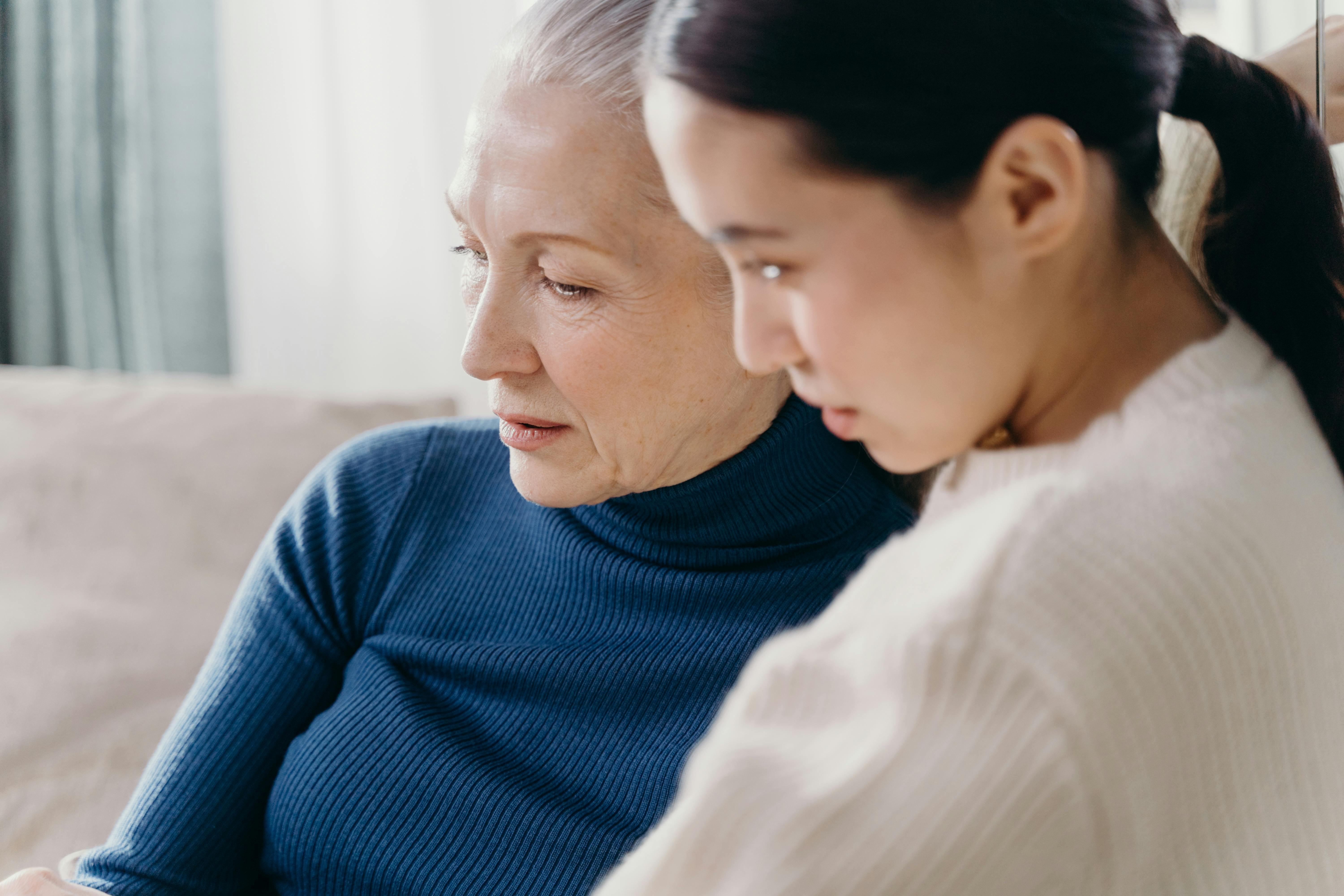 Senior woman and a younger woman seated on the couch | Source: Pexels