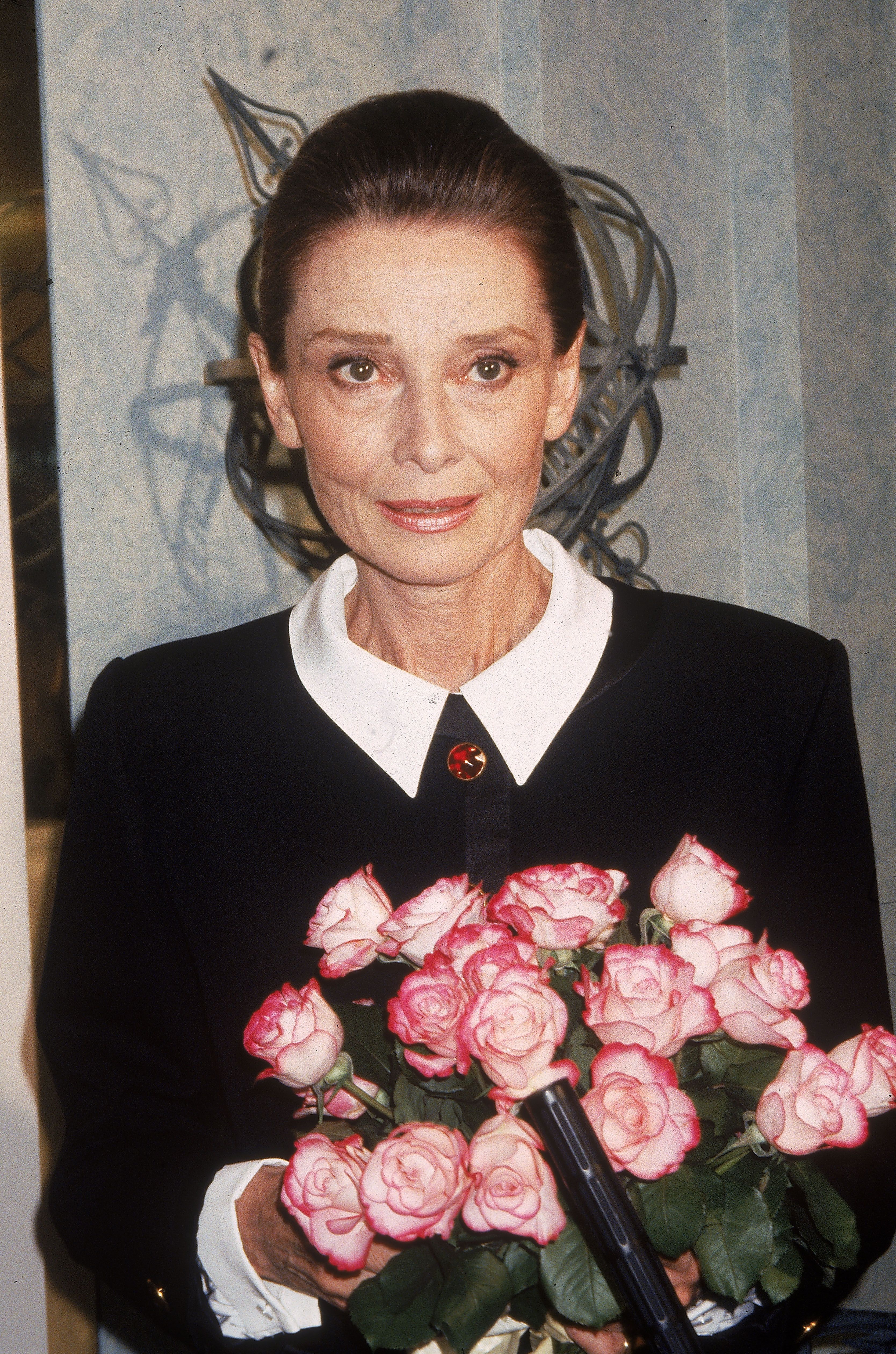Audrey Hepburn poses with a bouquet of flowers, circa 1985. | Getty Images