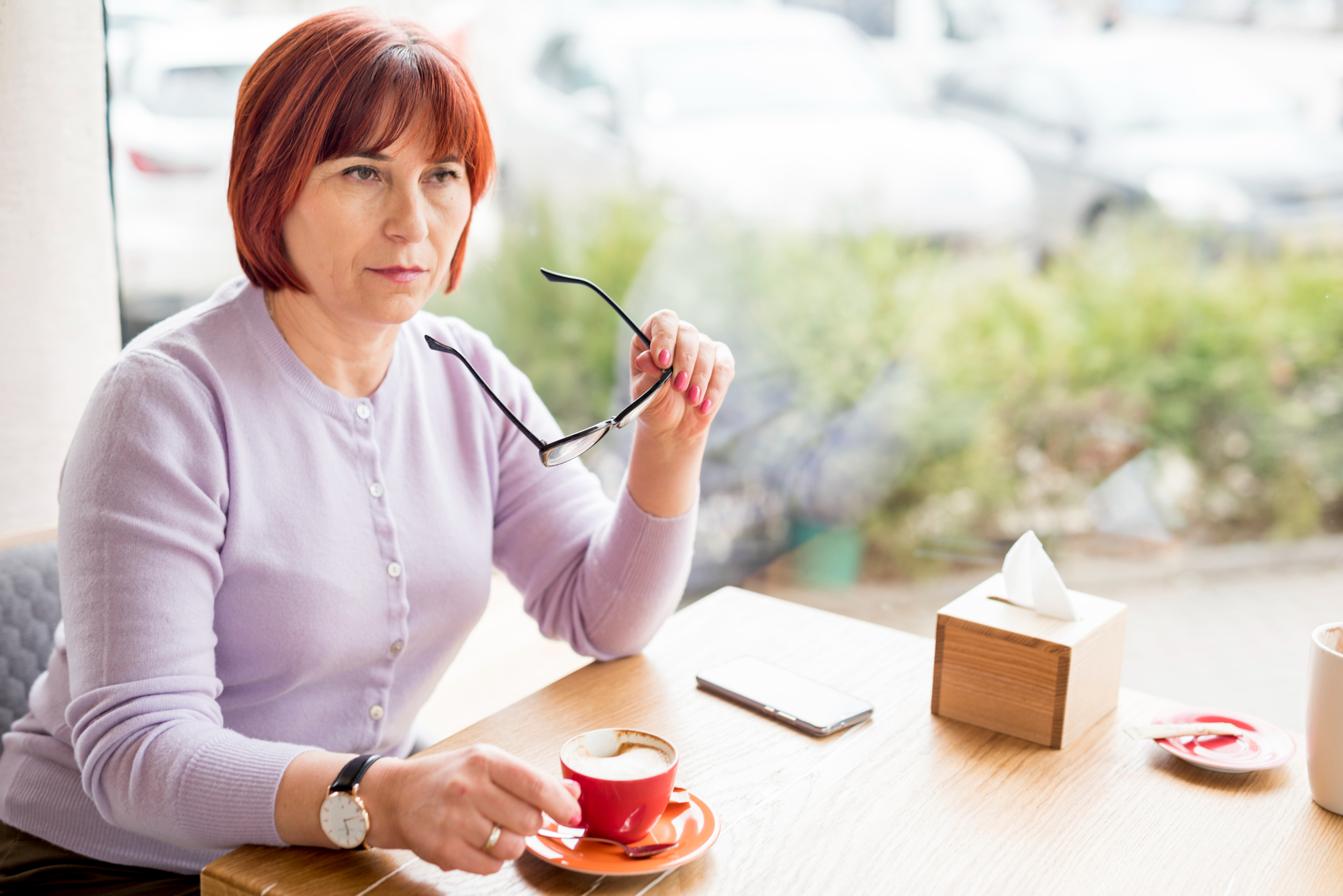 An entitled woman having coffee in a café | Source: Freepik