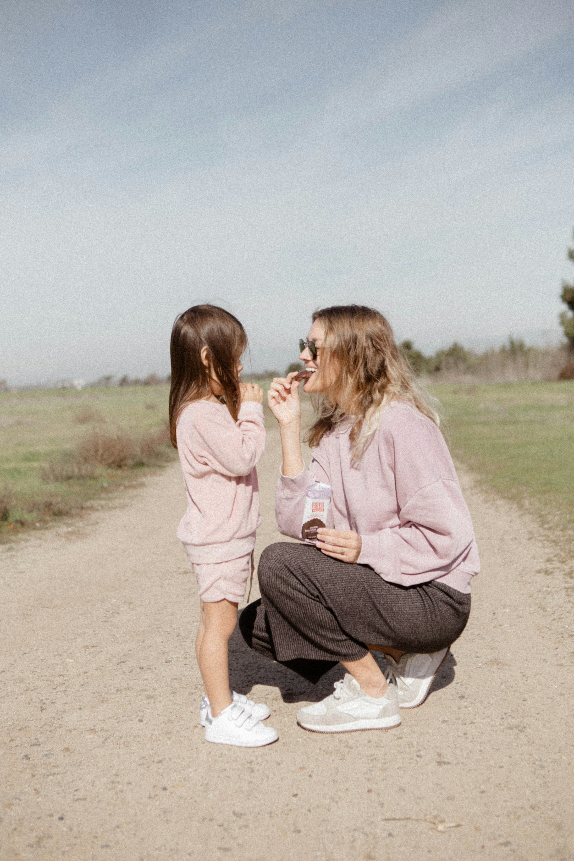 A mom and daughter on a dirt road | Source: Unsplash