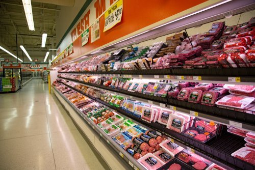 Packaged meats in supermarket refrigerated section. | Source: Shutterstock