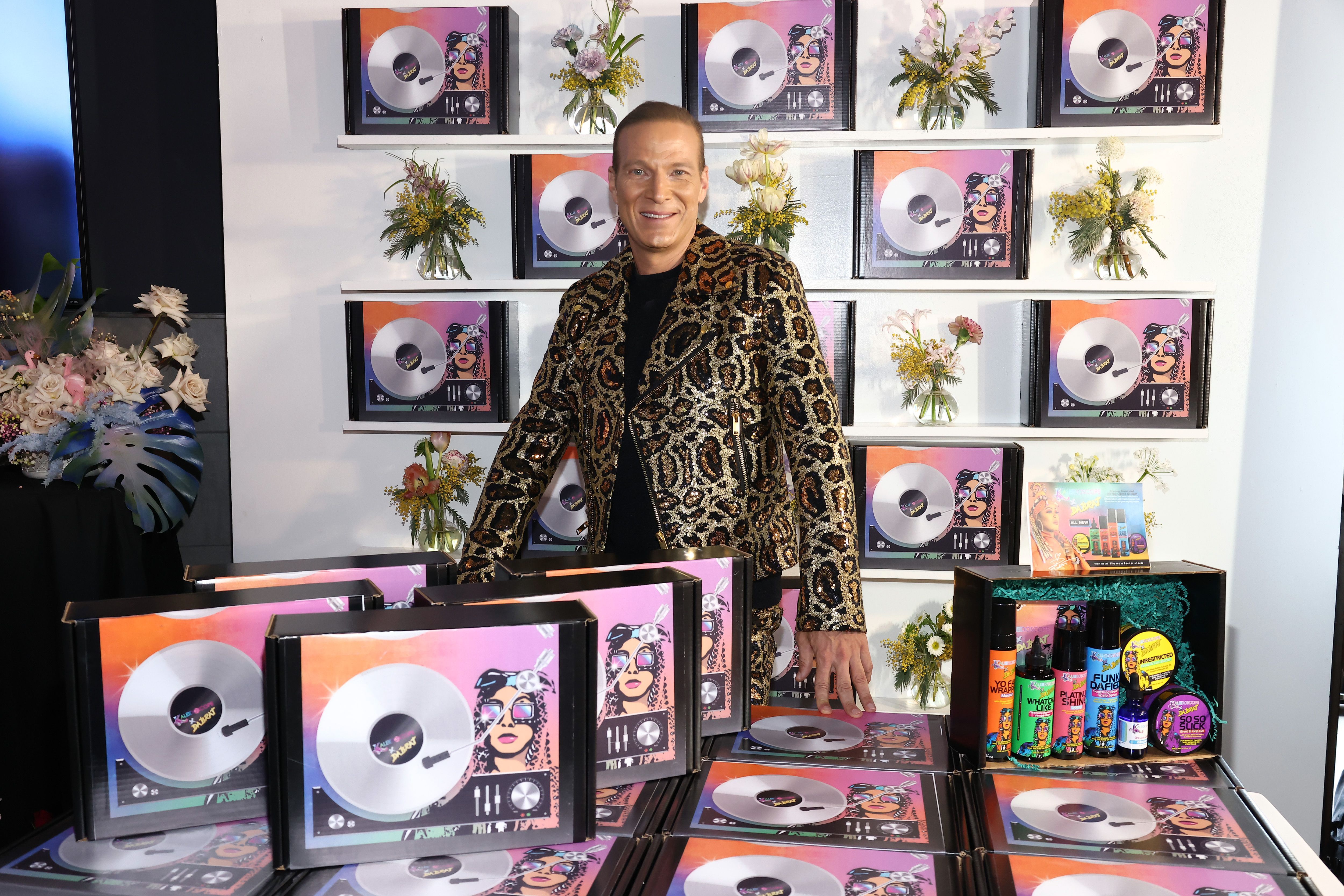 Lash Fary posing with products. | Source: Getty Images