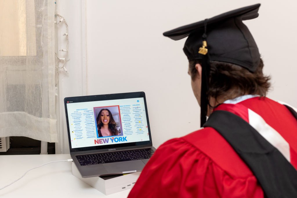 A graduate watches Cardi B from their laptop as she spoke during a virtual graduation ceremony hosted by Facebook on May 15, 2020, New York City | Source: Alexi Rosenfeld/Getty Images