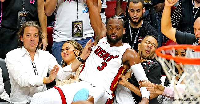 Dwyane Wade Gracefully Crashes into John Legend and Chrissy Teigen at Heat Game in Hilarious Photo