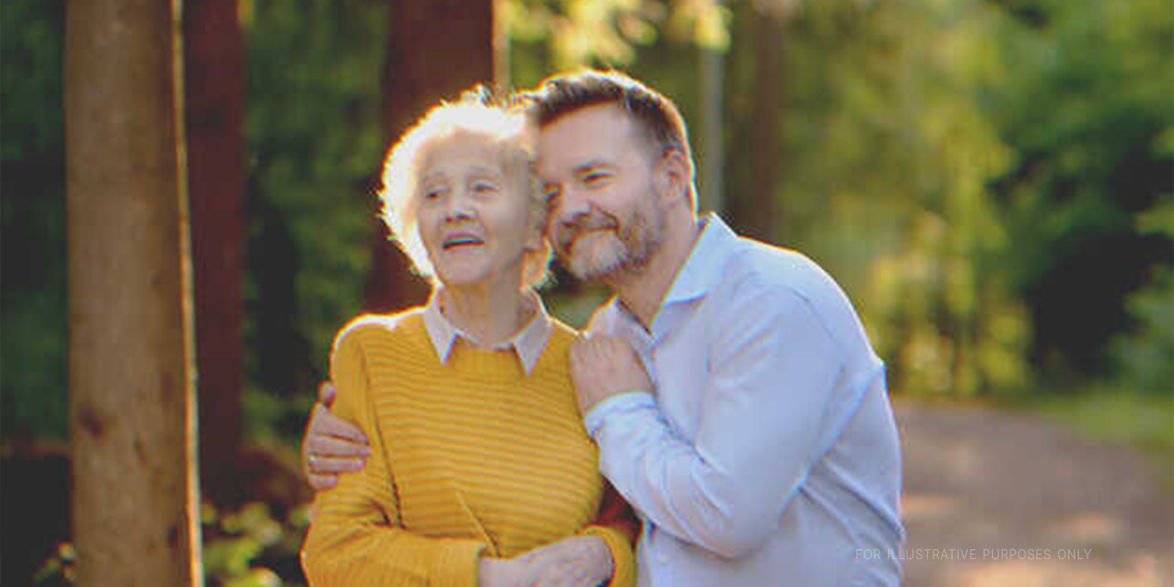 A young man hugging an elderly woman | Source: Shutterstock