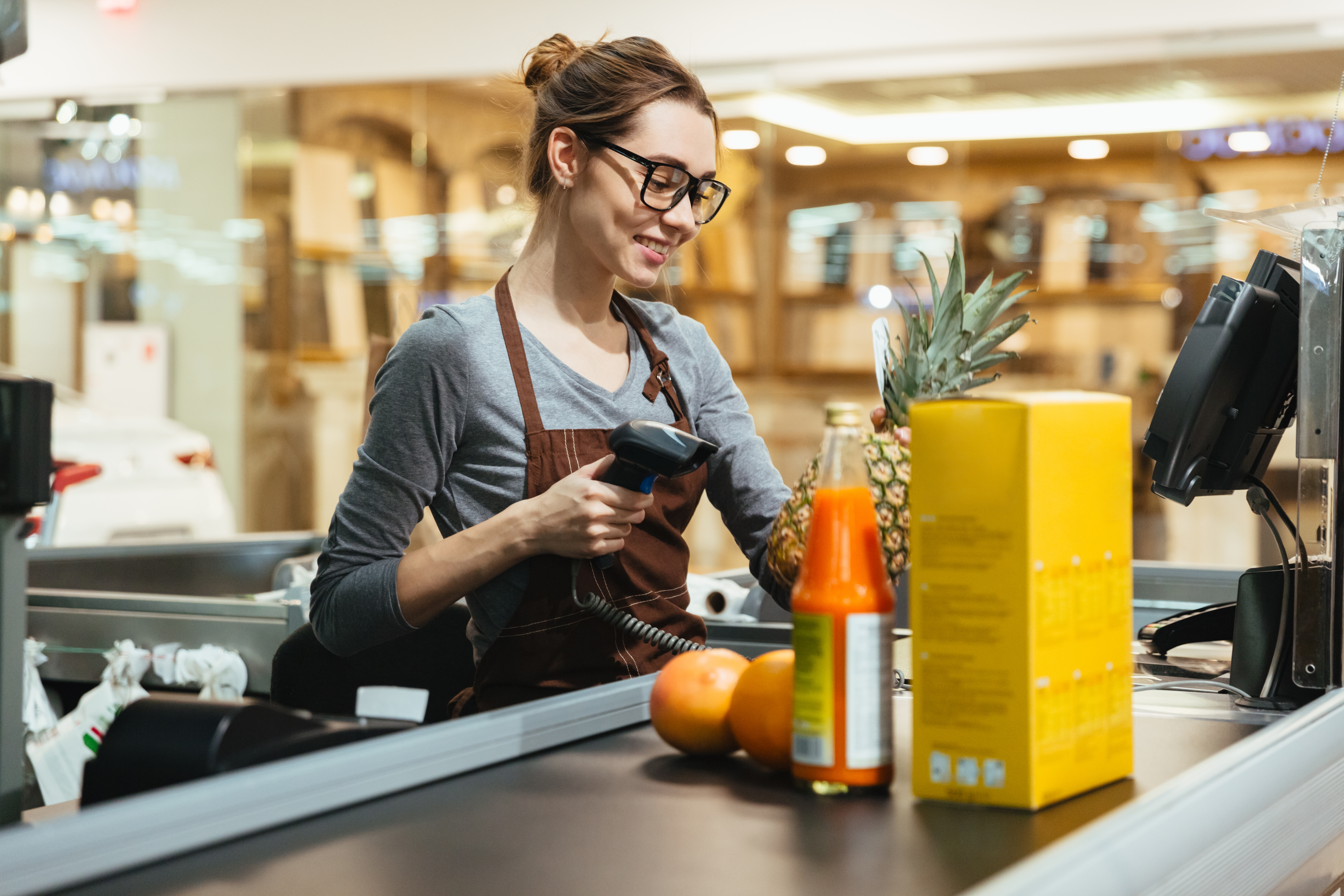 A female cashier at a grocery store | Source: Shutterstock