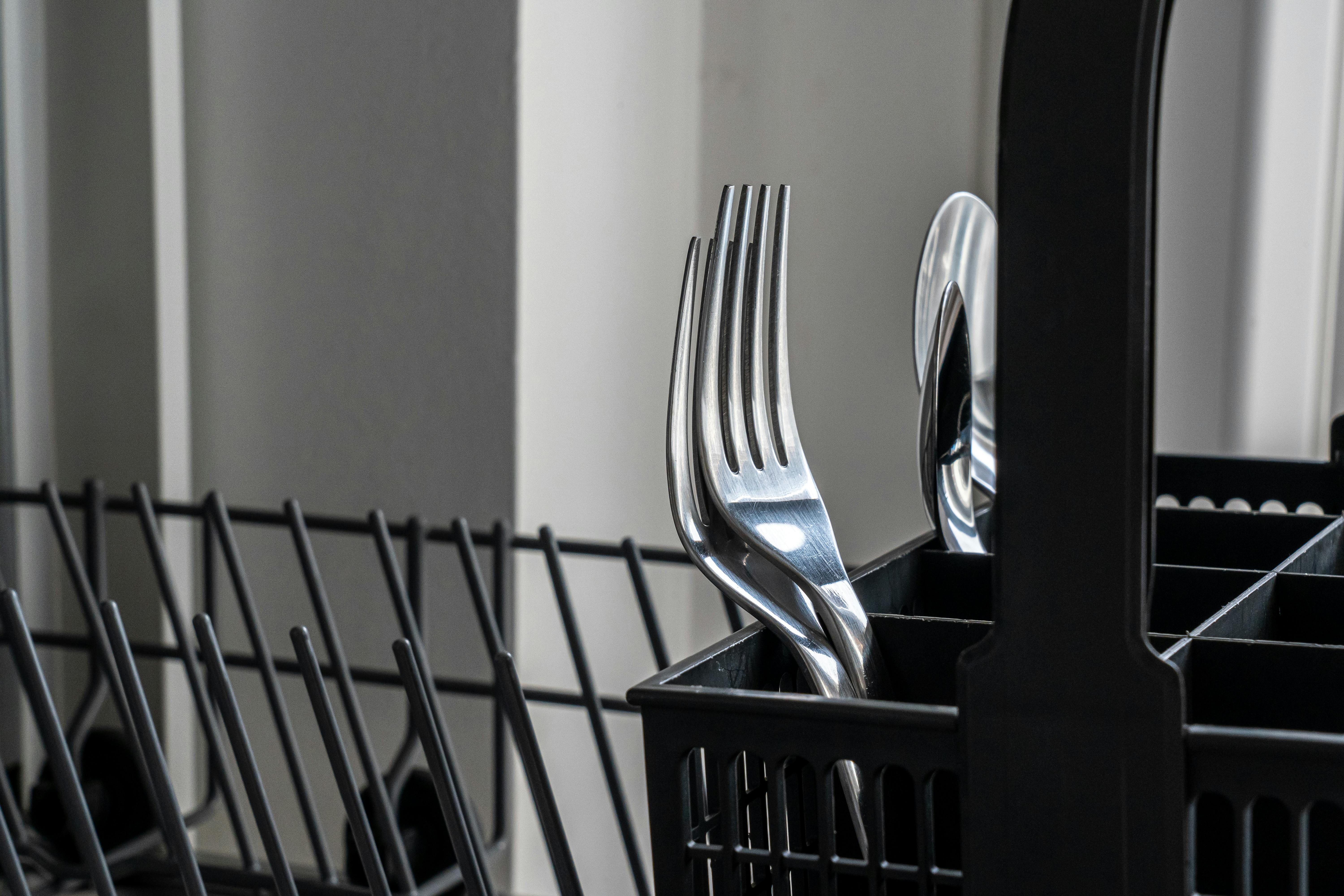 Utensils on a dishwasher | Source: Pexels