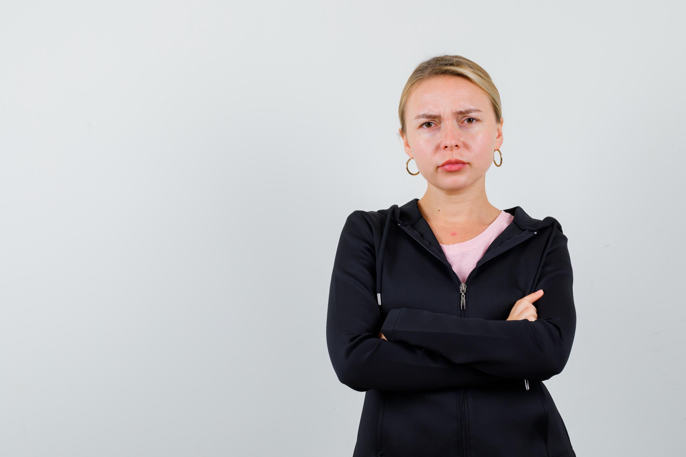 A serious woman with her arms crossed | Source: Freepik