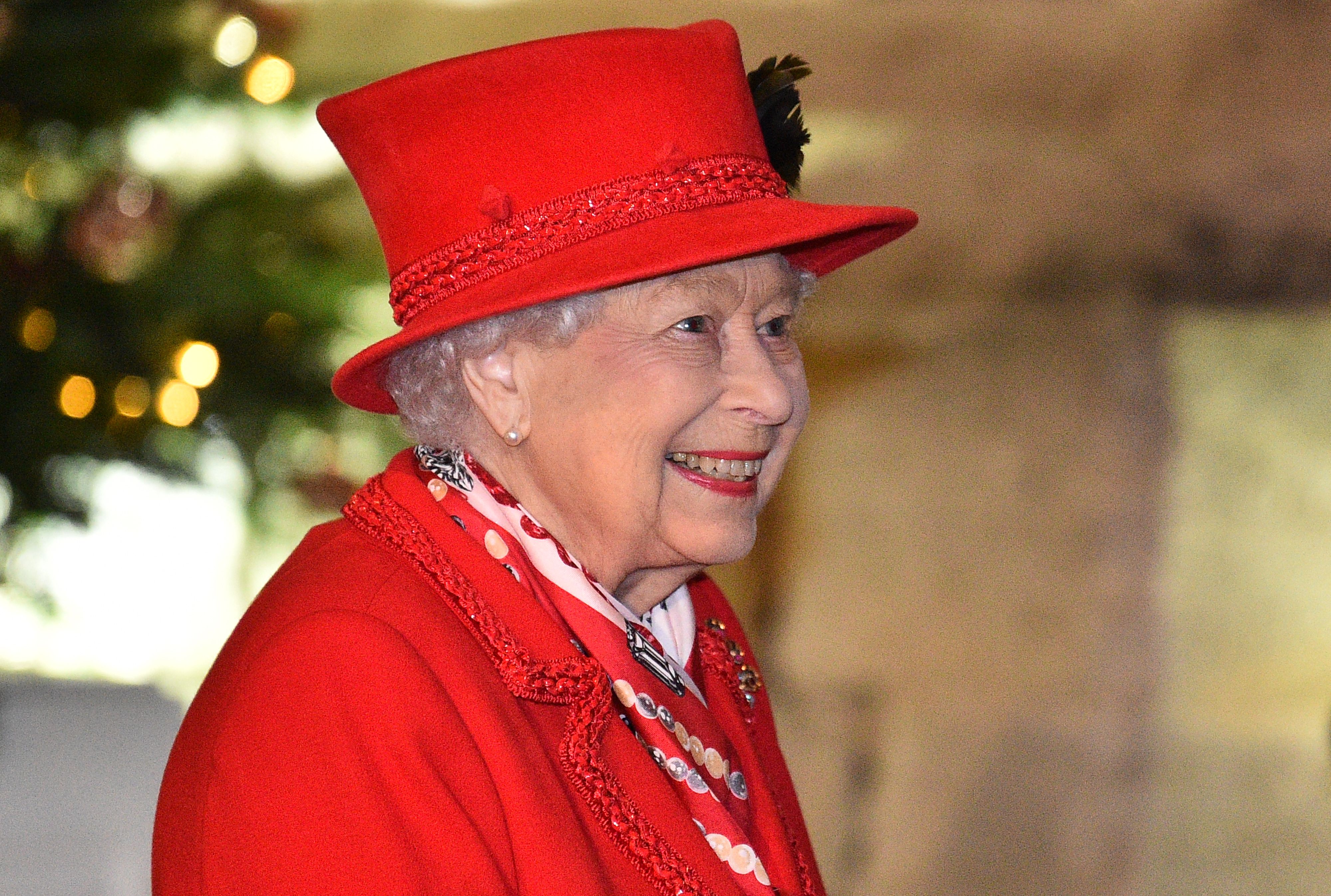  Queen Elizabeth II thanks local volunteers and key workers for the work they are doing during the coronavirus pandemic and over Christmas in the quadrangle of Windsor Castle on December 8, 2020 | Getty Images