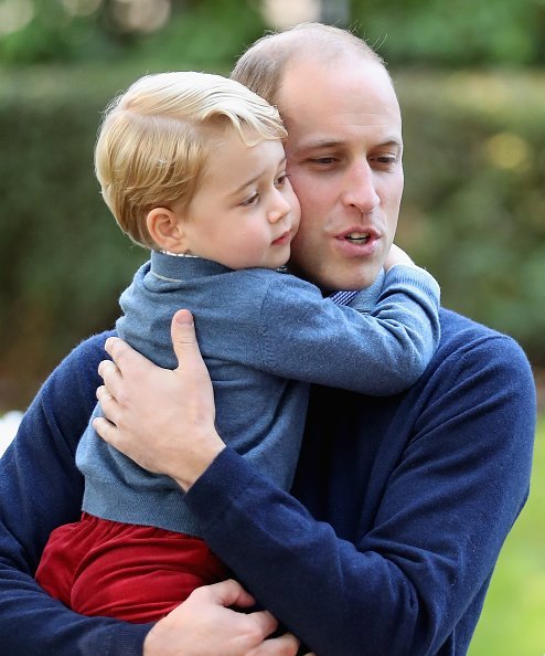 Prince George of Cambridge with Prince William, Duke of Cambridge at a children's party for Military families | Photo: Getty Images