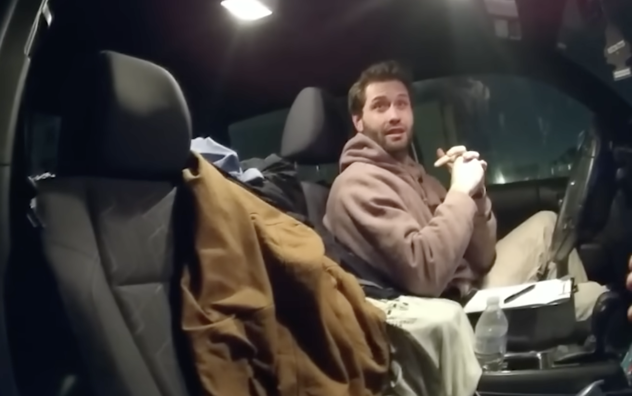 Dakota Mortensen talks to police after a noise complaint | Source: YouTube/@LawAndCrime