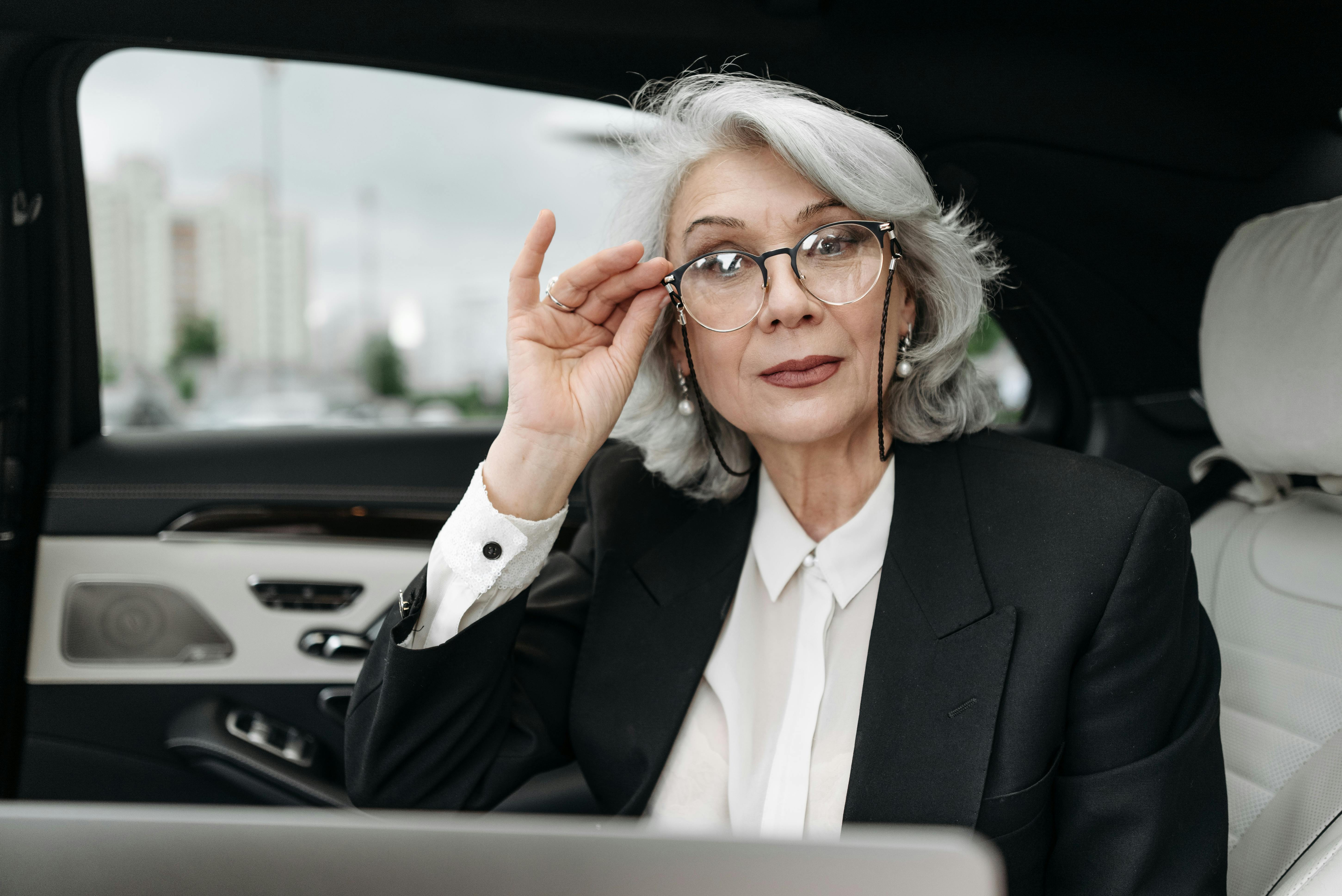 A woman posing in a car | Source: Pexels