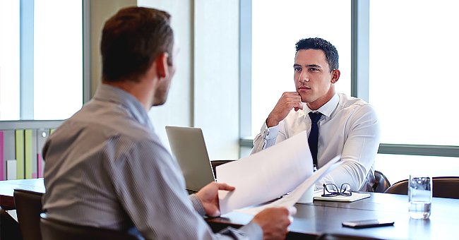 Two men discussing in an office. | Photo: Shutterstock