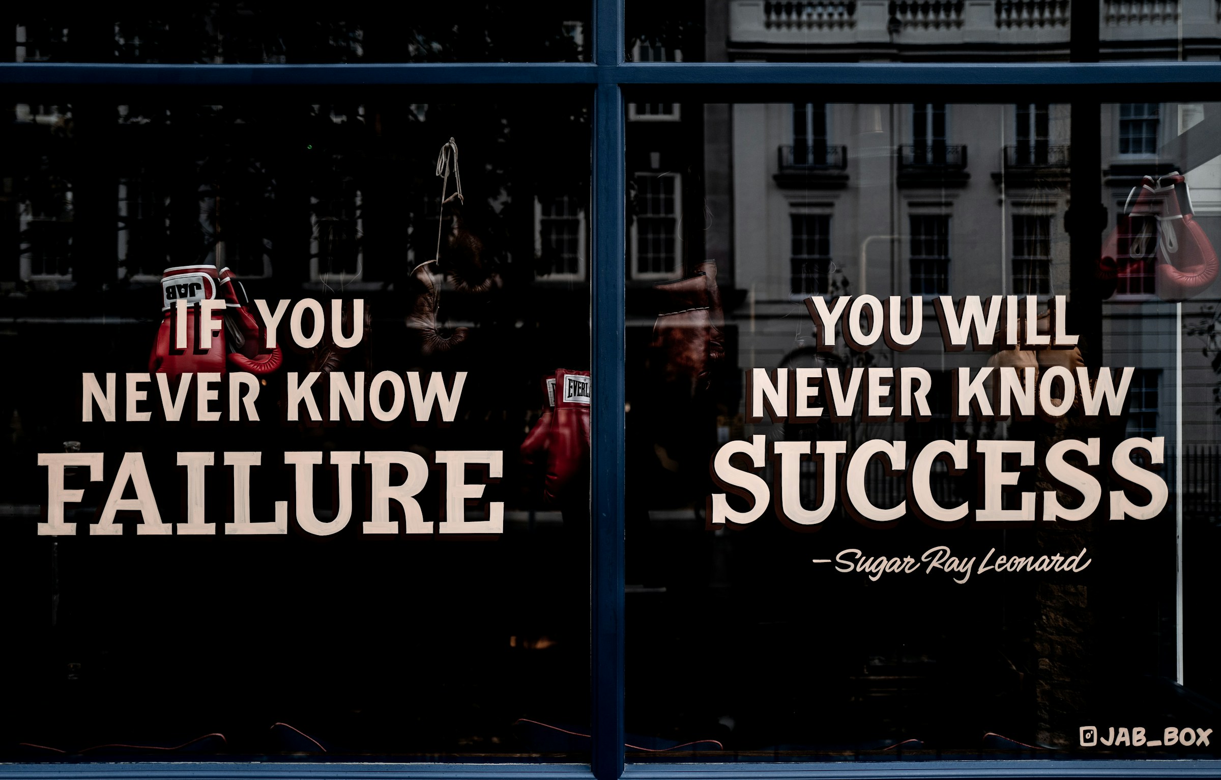 A motivational quote written on a glass window | Source: Unsplash