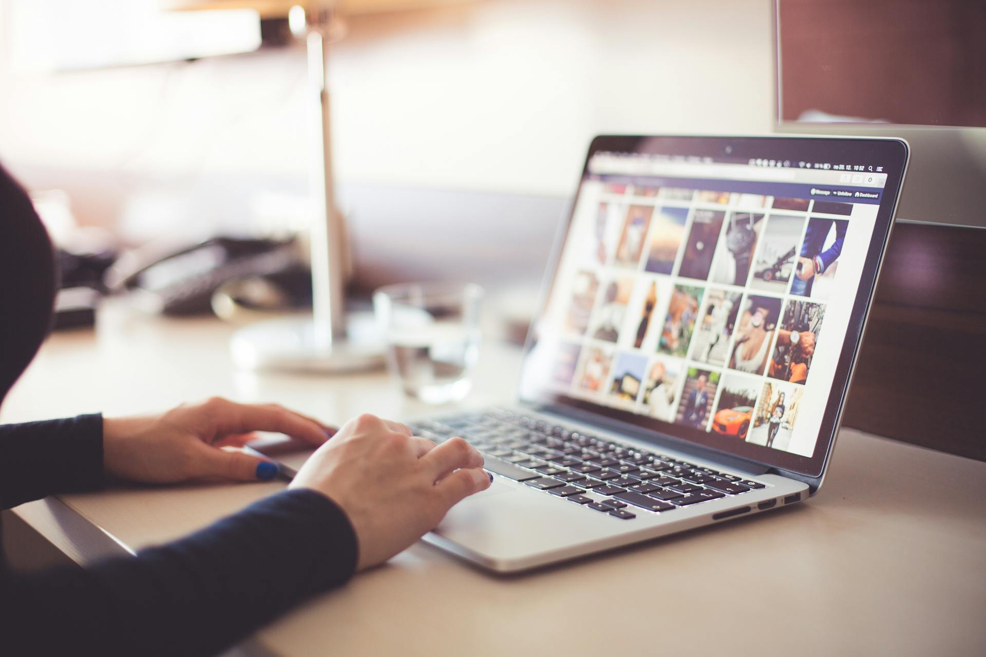 A person using a laptop to view photos on social media | Source: Pexels