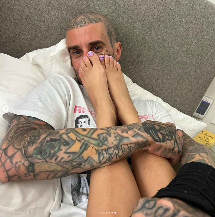 Travis Barker posing for a picture with Kourtney Kardashian's feet, posted on February 15, 2024 | Source: Instagram/travisbarker