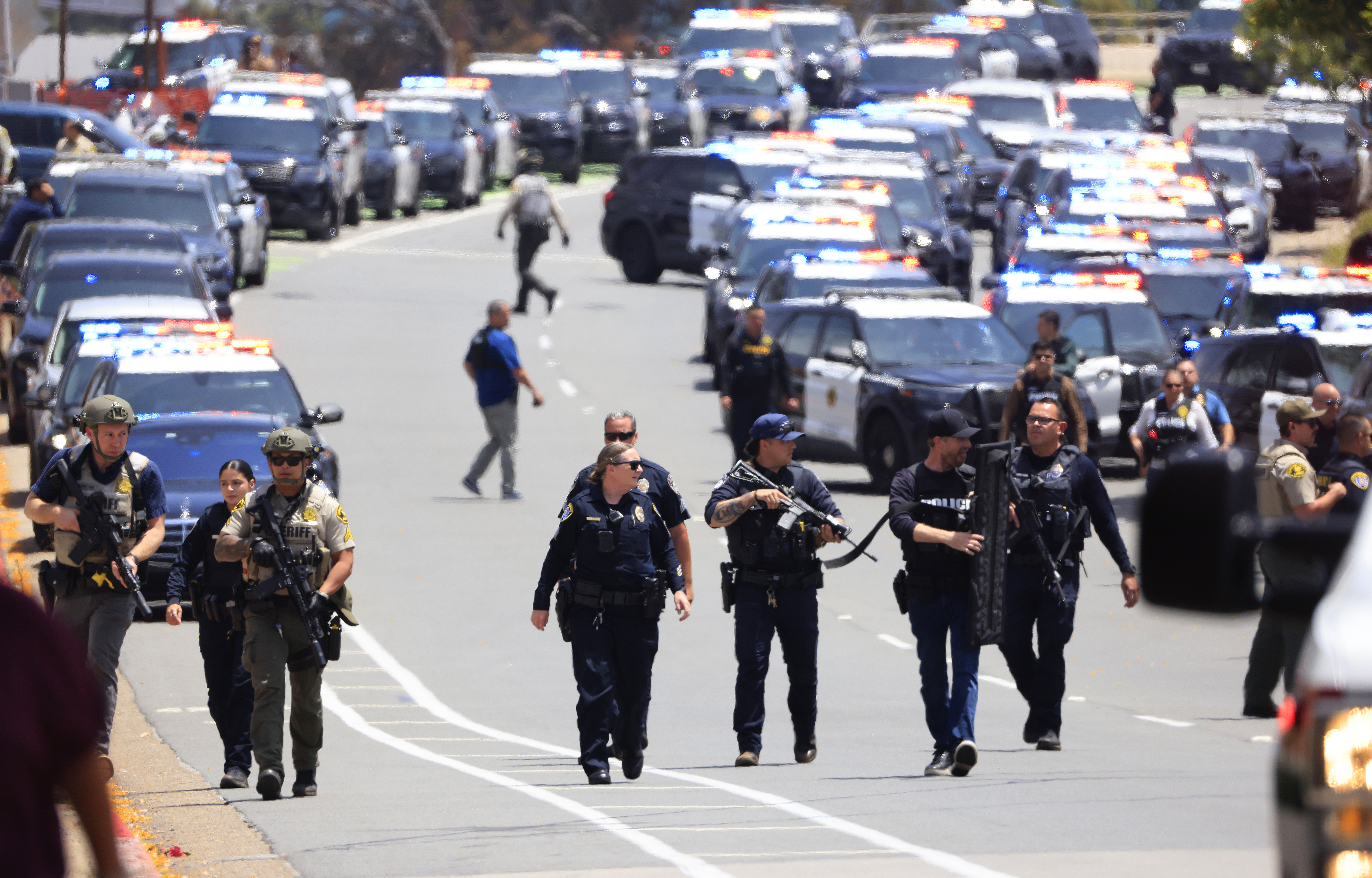 Law enforcement officers escort people away from the Islamic Center of San Diego after a shooting on May 18, 2026, in San Diego, California | Source: Getty Images