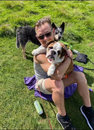 Adam Rickitt pictured holding Daphne while surrounded by his dogs during a walk, captured in a family moment from a post dated January 4, 2026. | Source: Instagram/katyrickitt