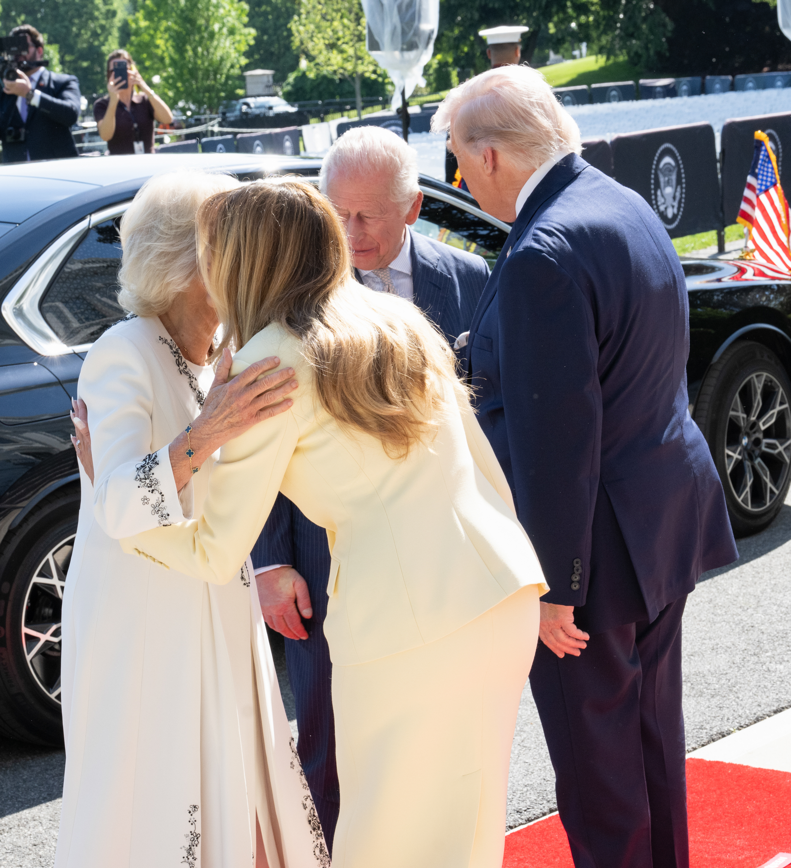 Queen Camilla and First Lady Melania Trump were seen exchanging a warm cheek-to-cheek greeting beside the waiting car on the White House grounds, as King Charles III stood close by in conversation with U.S. President Donald Trump. The moment highlighted the blend of personal warmth and formal protocol that defined the opening engagements of the state visit marking the United States' 250th anniversary.
