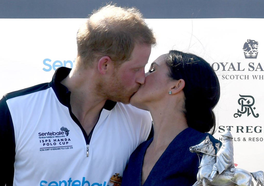 Meghan Markle and Prince Harry kiss after the Sentebale ISPS Handa Polo on July 26, 2018 in Windsor | Source: Getty Images