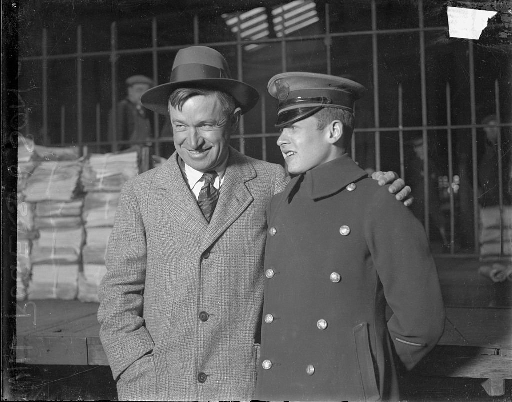 Will Rogers standing with his son in front of a wooden platform, Chicago, Illinois, 1928 | Photo: Getty Images